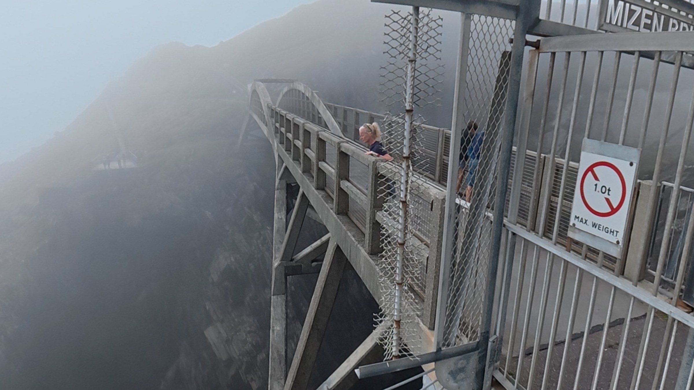 Sue standing on Mizen Head Footbridge in the fog