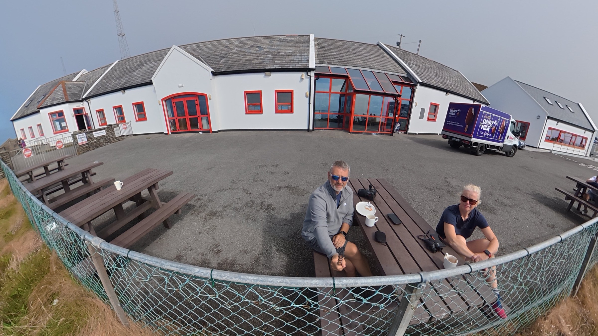 John and Sue sitting outside the Mizen Head Visitor Centre café