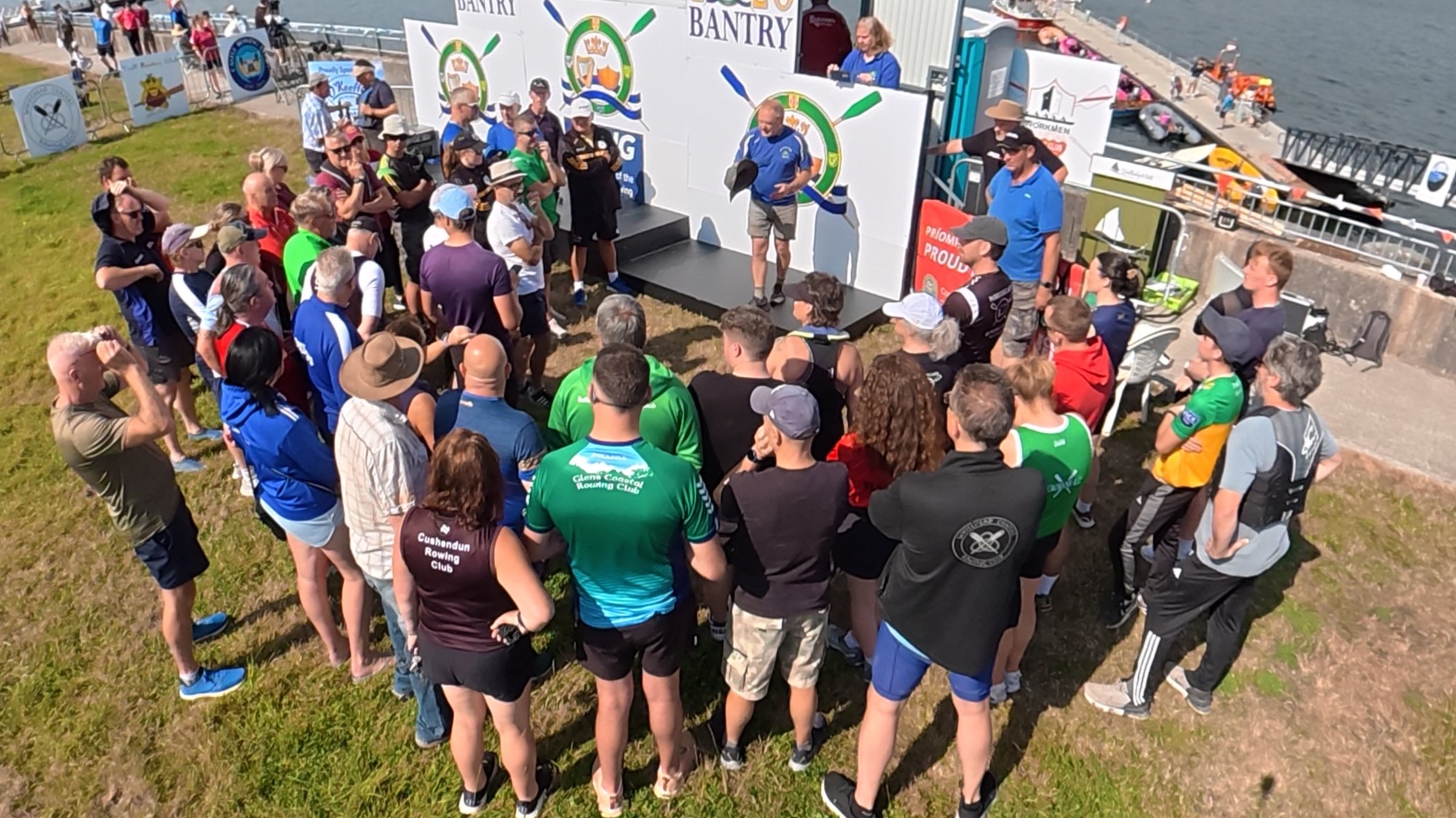 Rowers gathered in a circle for the captains' briefing