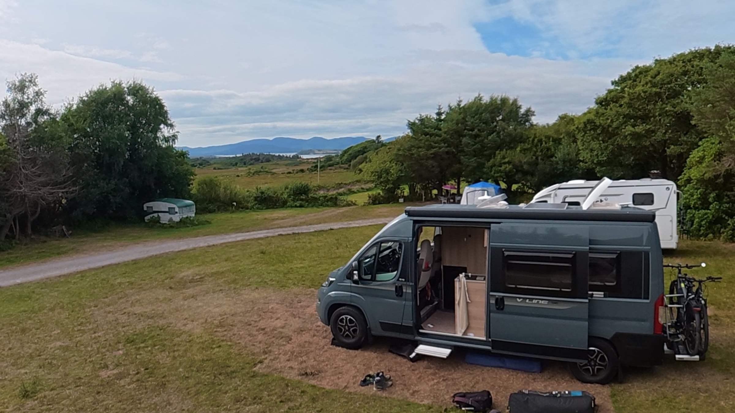 Ollie parked on a grassy pitch overlooking the landscape at Creveen Lodge