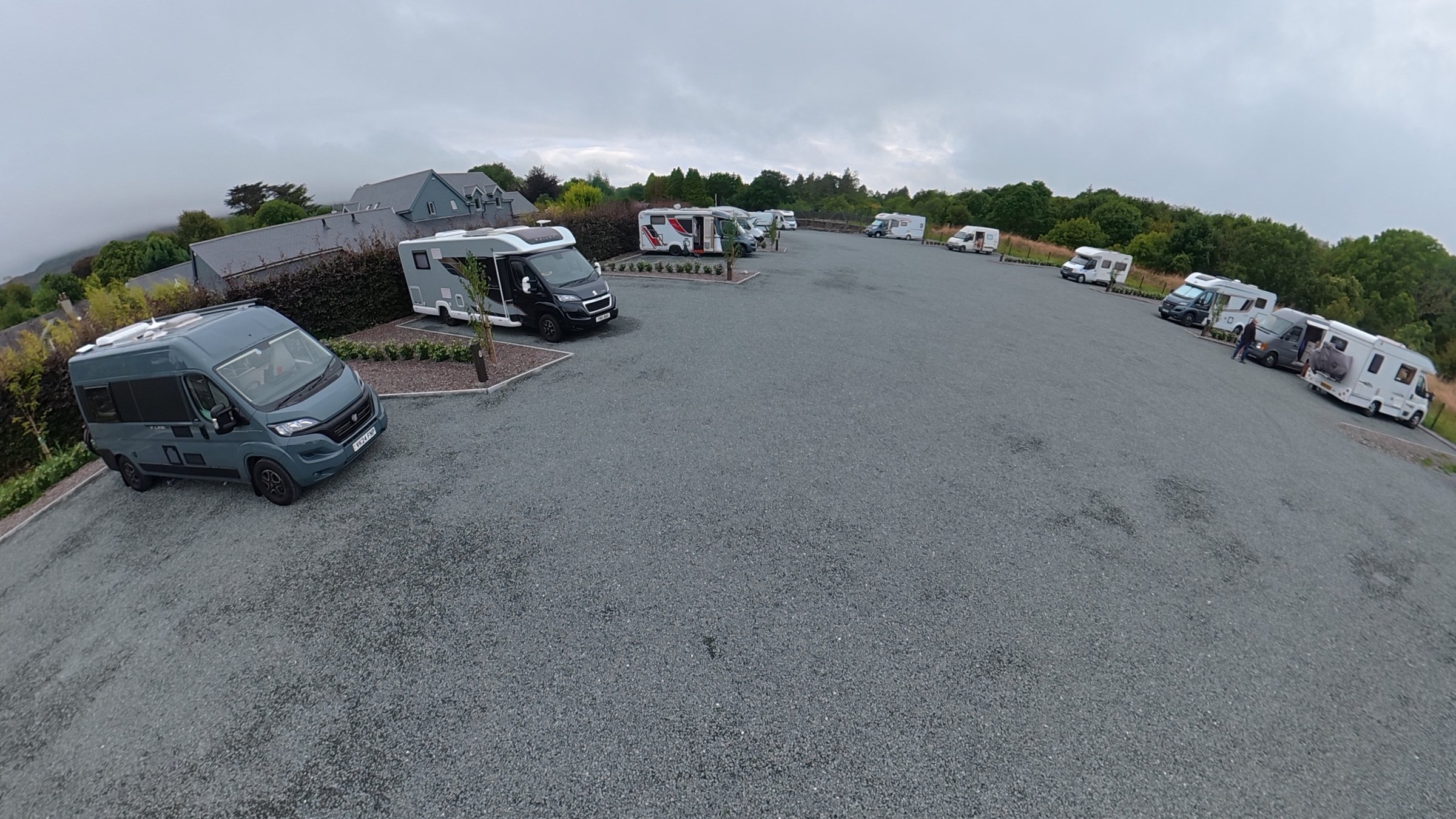 Campervans parked on spacious gravel pitches at Kenmare Aire