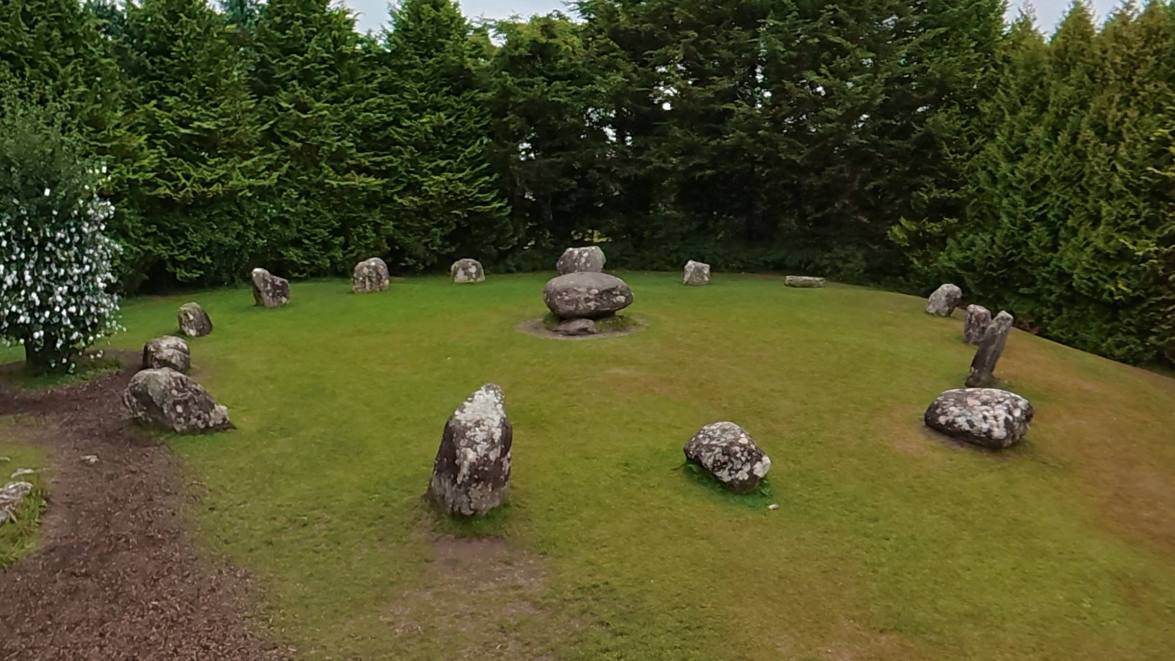 The low boulders of Kenmare Stone Circle surrounded by trees