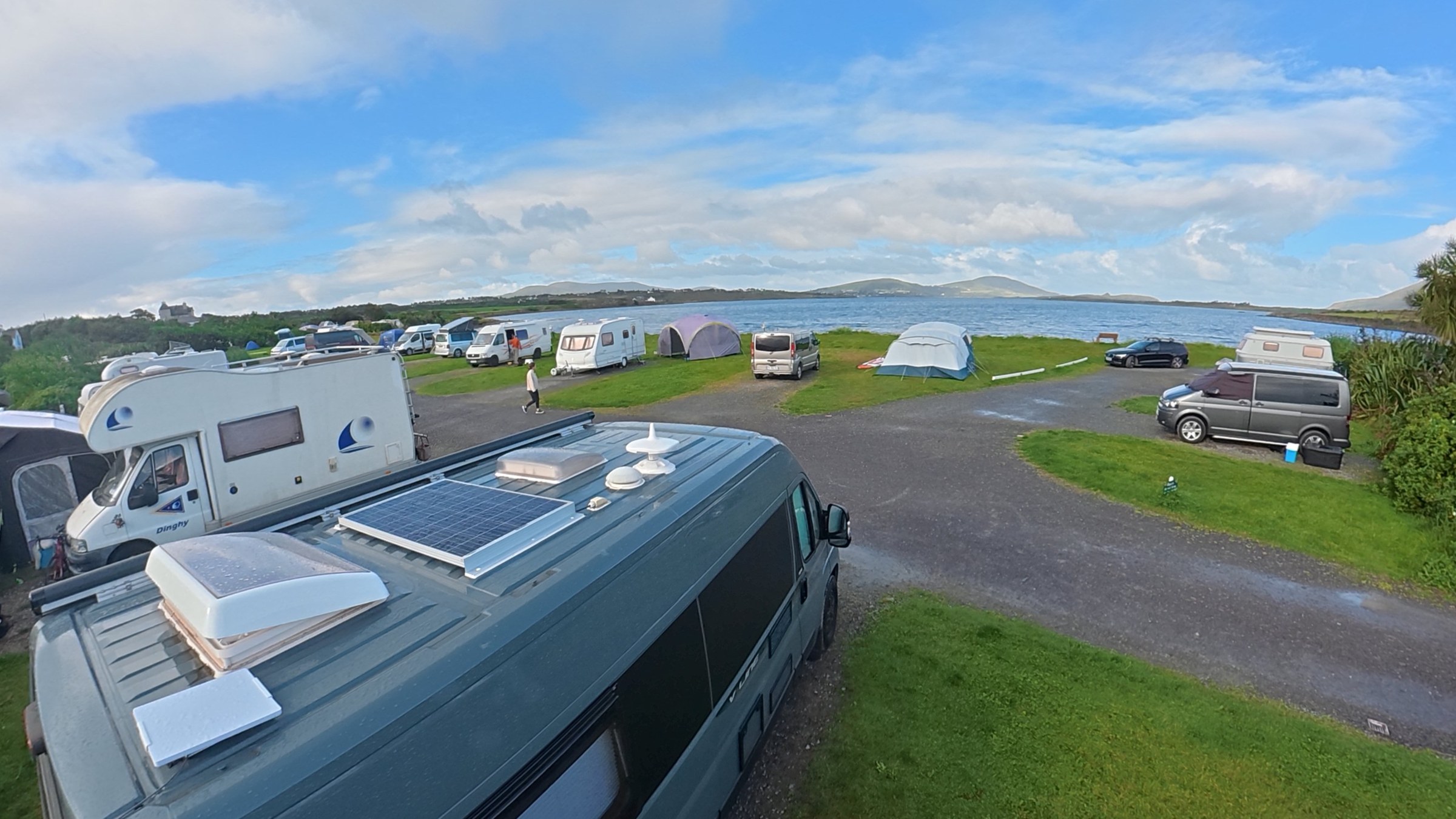 Ollie parked among campervans at Mannix Point on a bright morning