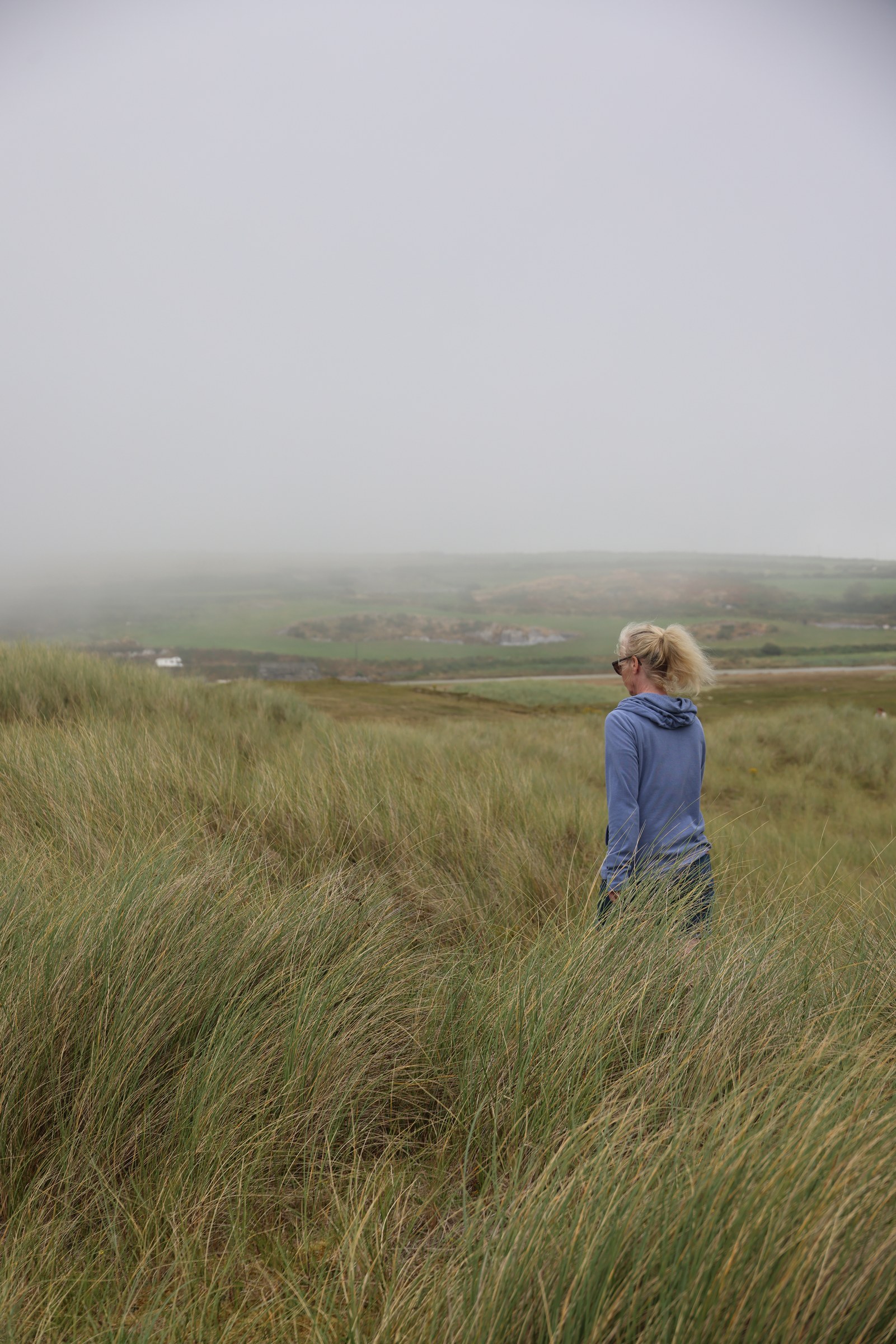 Sue standing among the dune grass at Barleycove