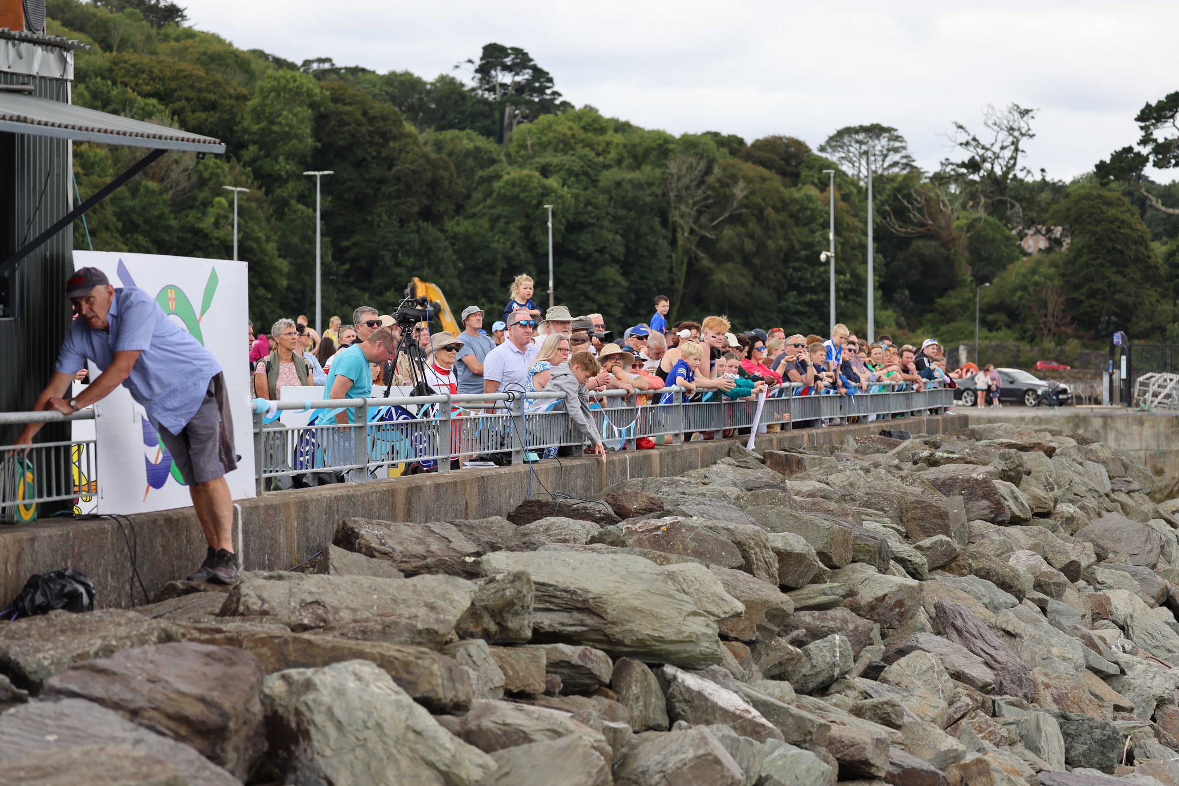 Spectators watching the rowing from the rocks beside the course