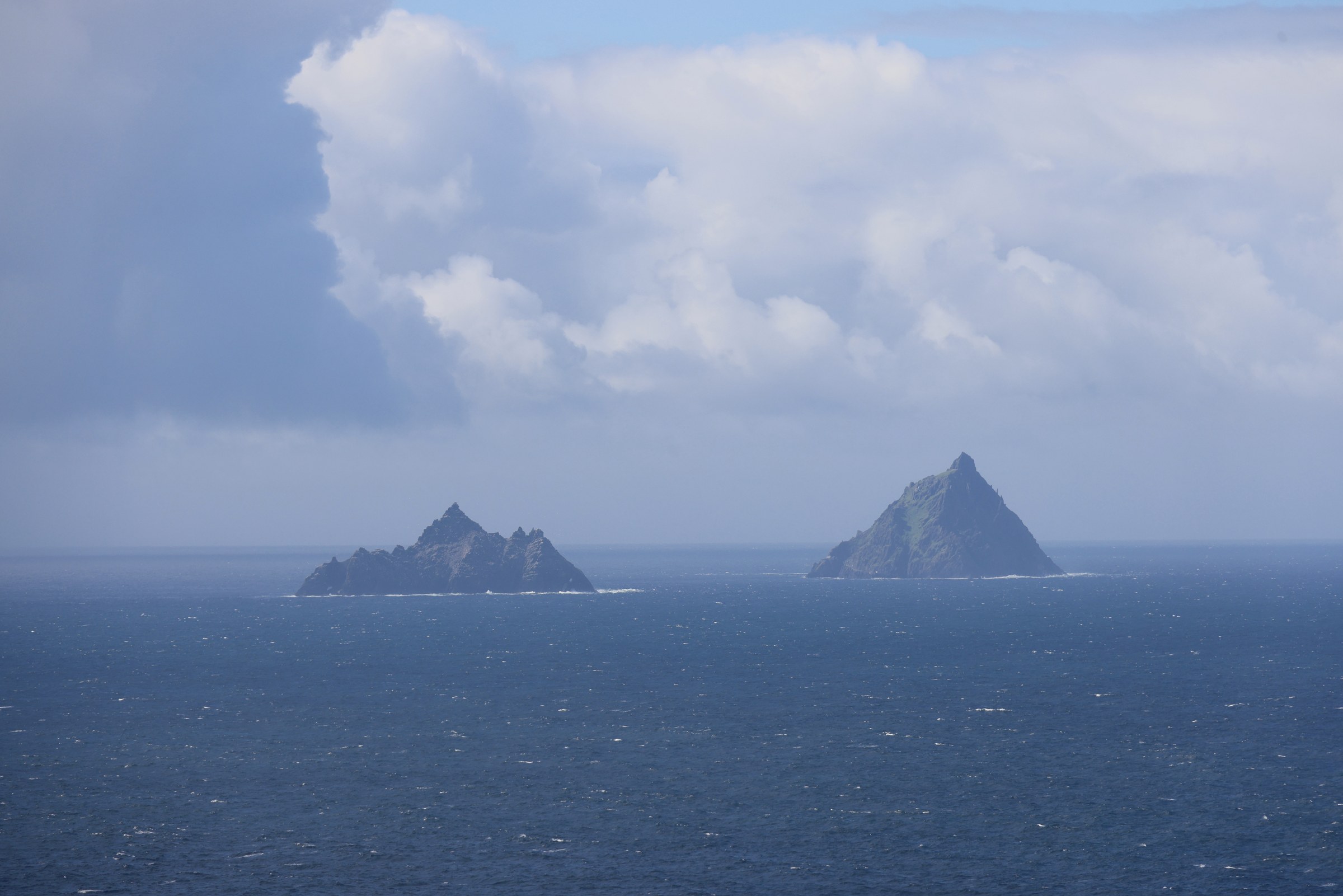 Skellig Michael and Little Skellig appearing through mist offshore