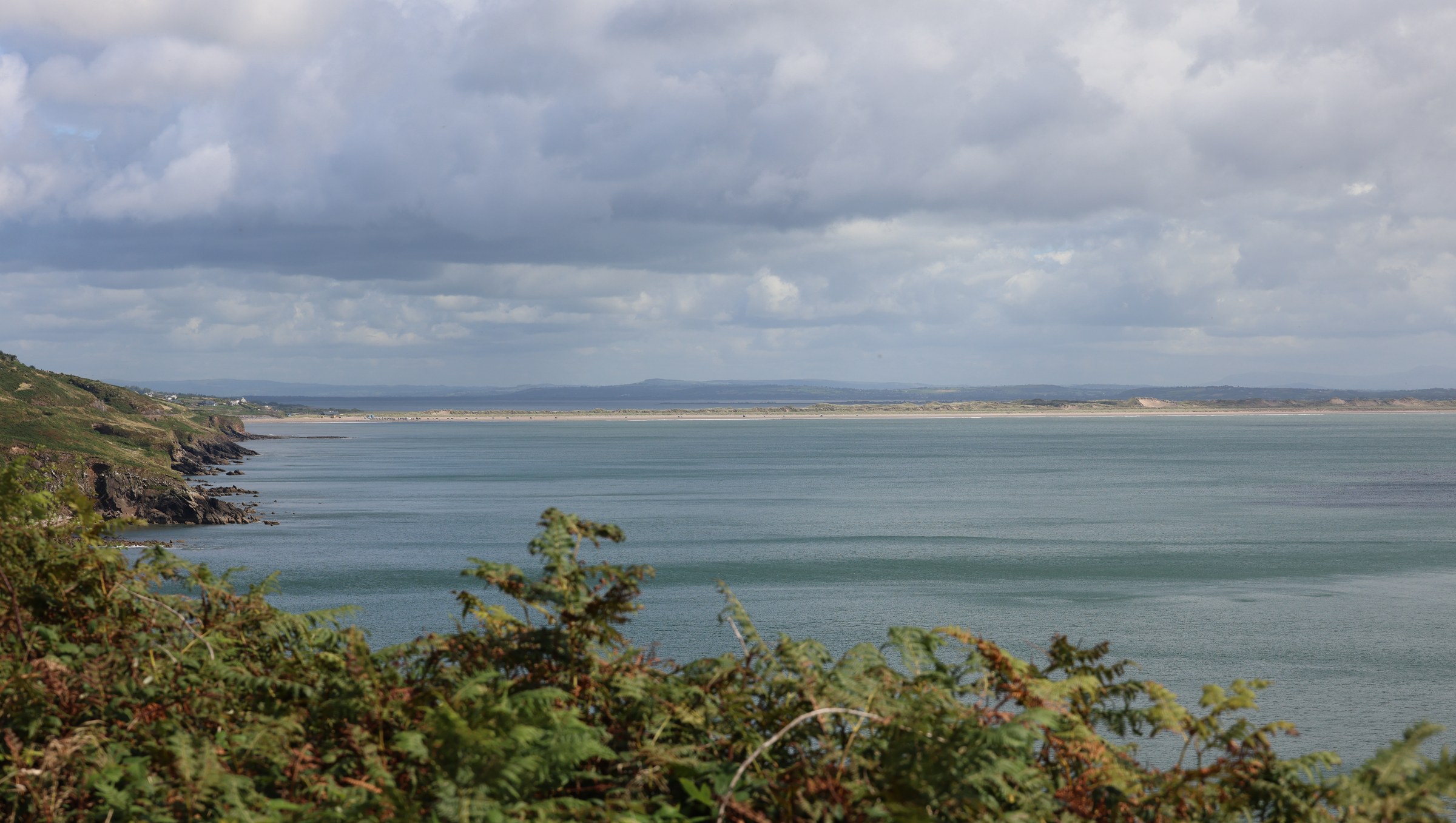 Inch Beach curving along Dingle Bay beneath broken cloud