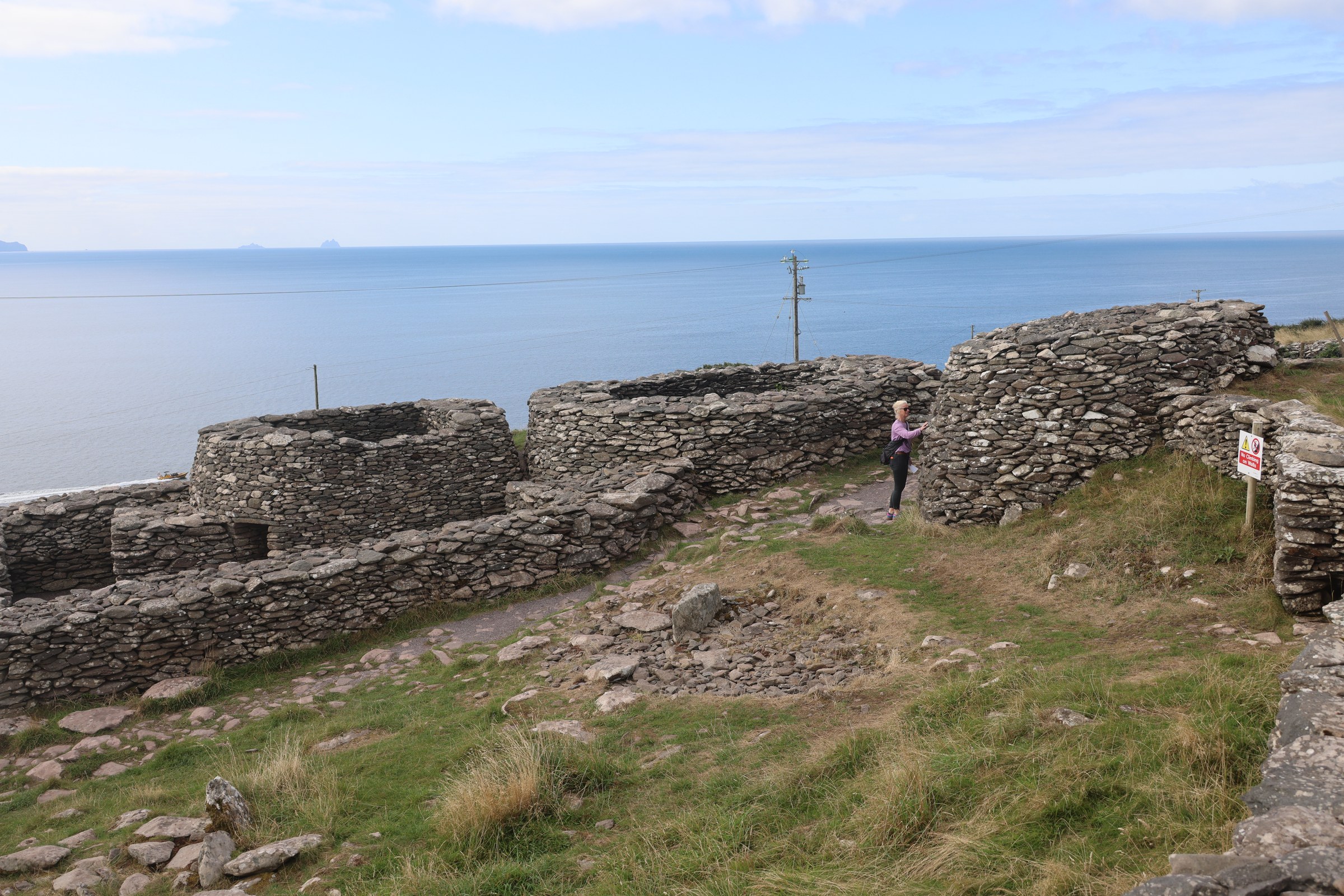 The low dry-stone walls and clocháin of a Fahan beehive settlement