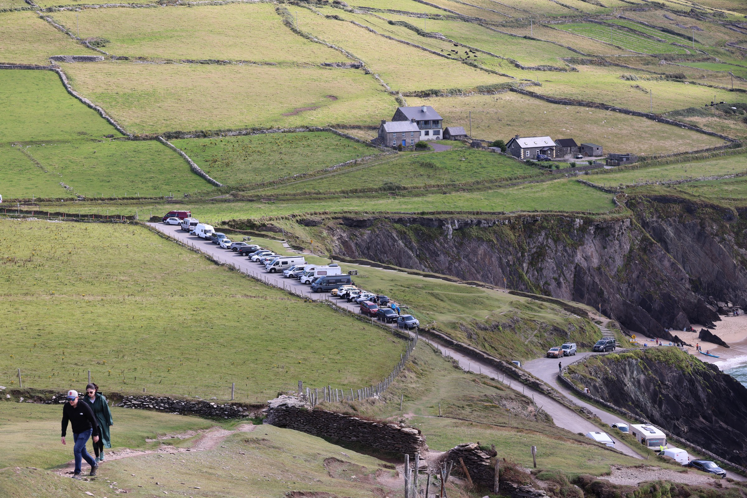 The busy Dunmore Head car park seen from the hillside above