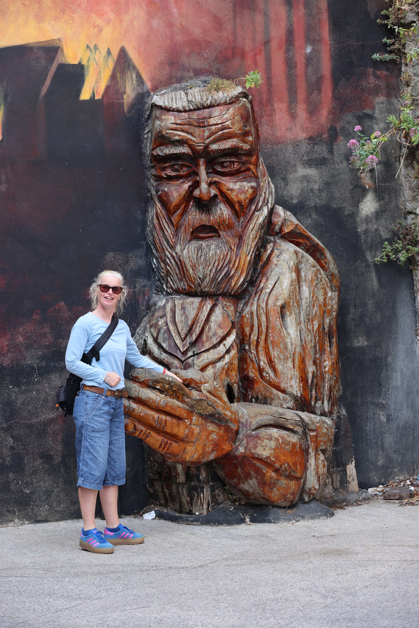 Sue standing beside a large carved Viking figure in Waterford