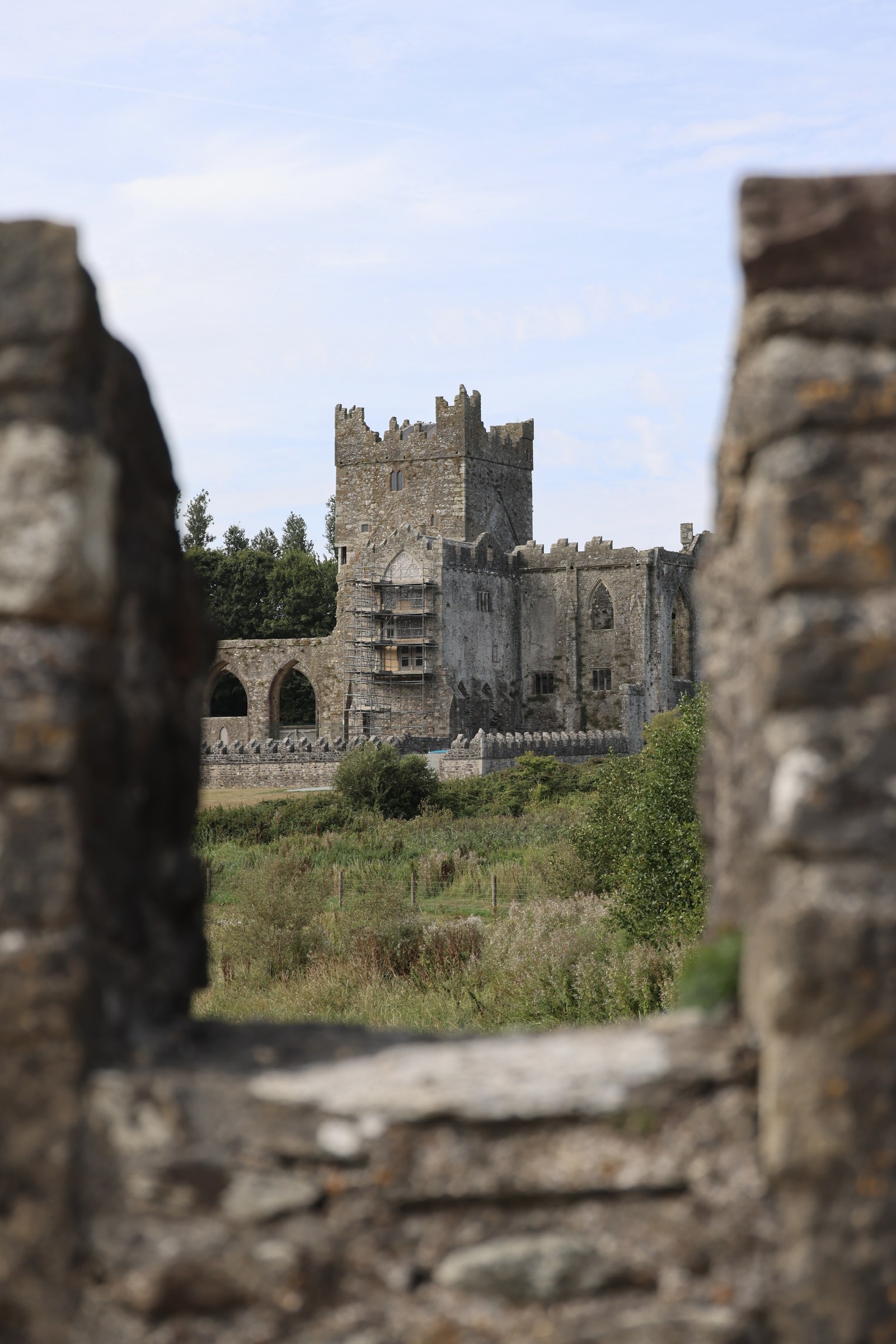 Tintern Abbey framed through an opening in the old stone bridge