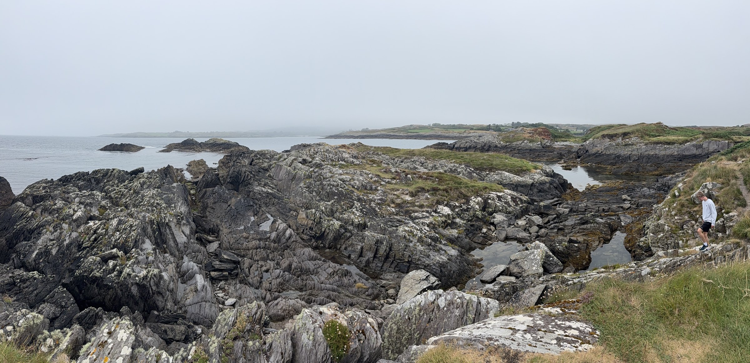 Rocky shoreline and calm water at Toormore Bay