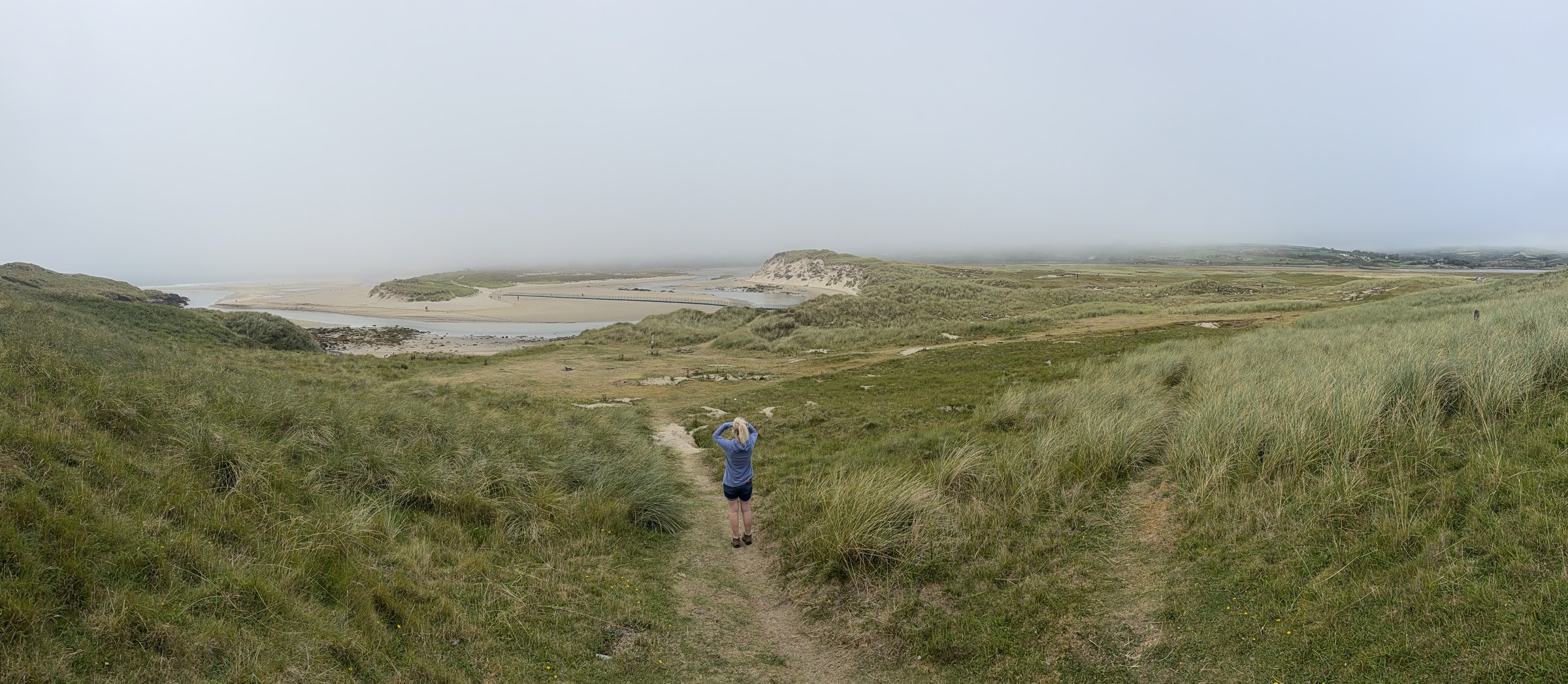 Sue walking along the sandy path through the dunes