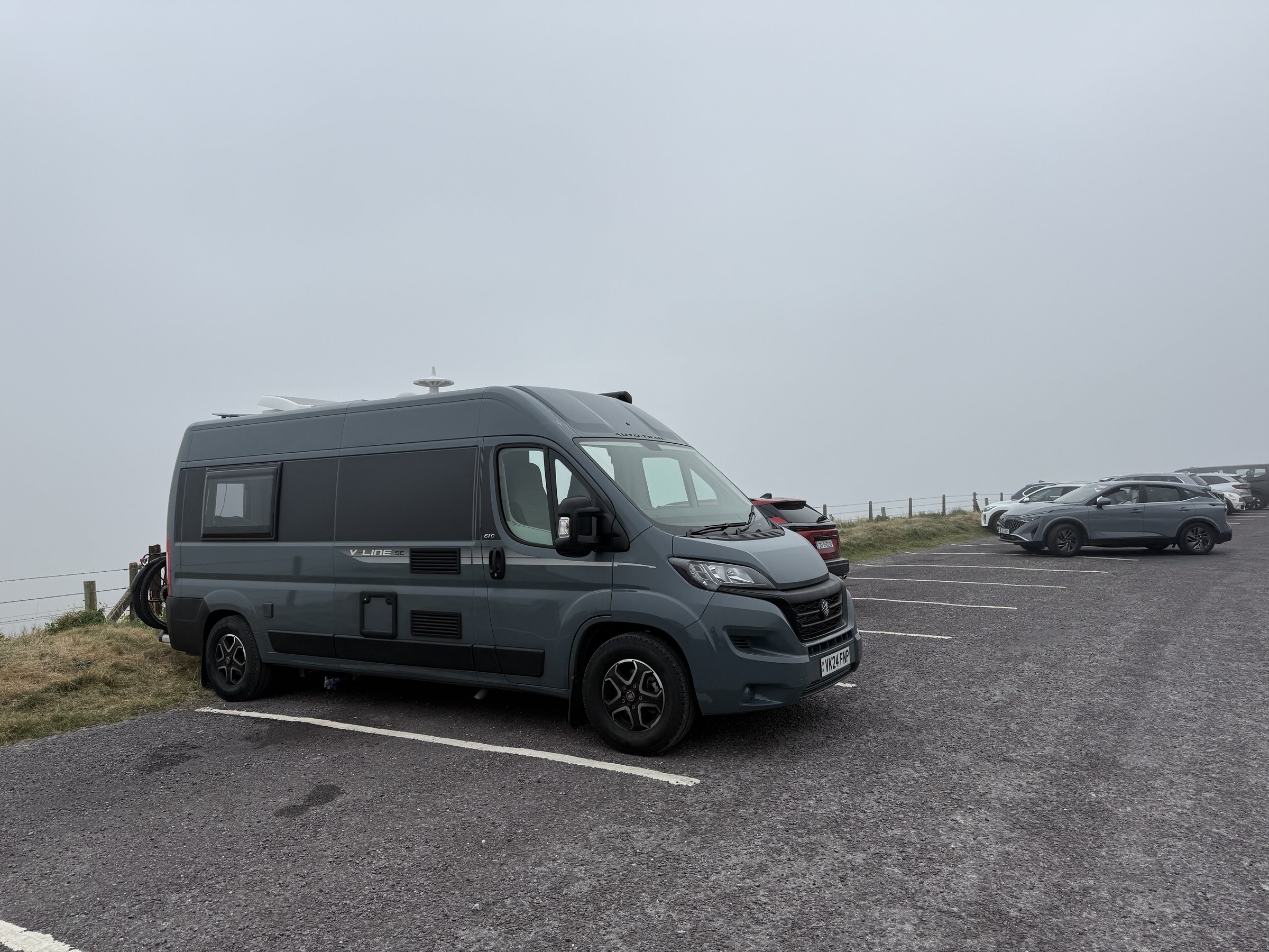 Ollie parked on a slope in the mist at Mizen Head