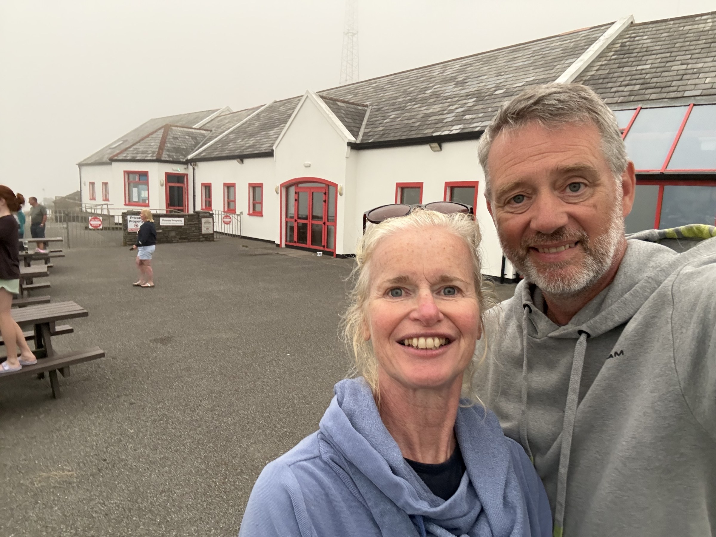 John and Sue taking a selfie outside the misty visitor centre