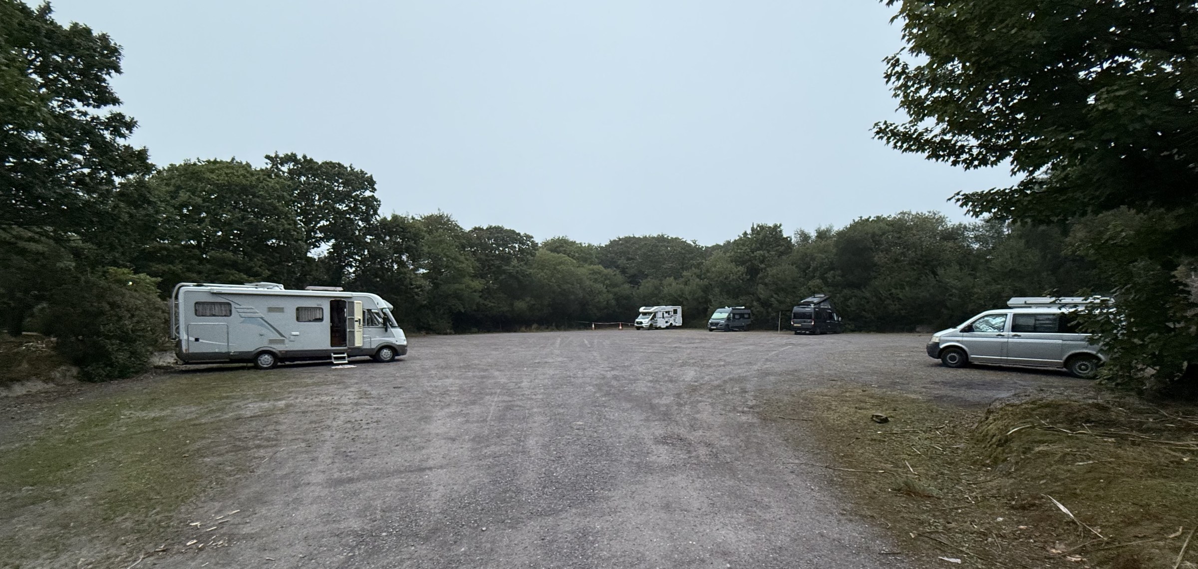Campervans spaced around the large parking area at the Westlodge Hotel