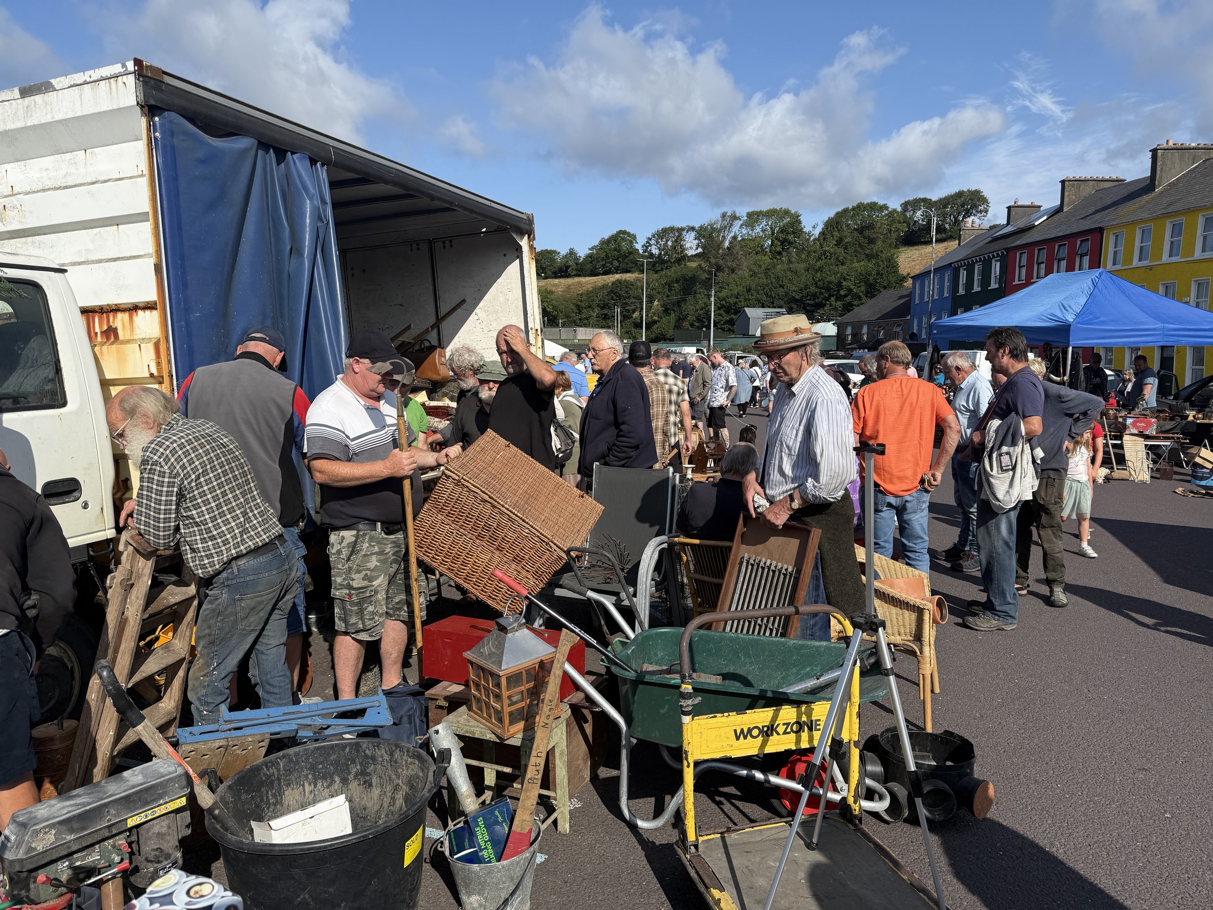 Shoppers examining second-hand furniture and household items