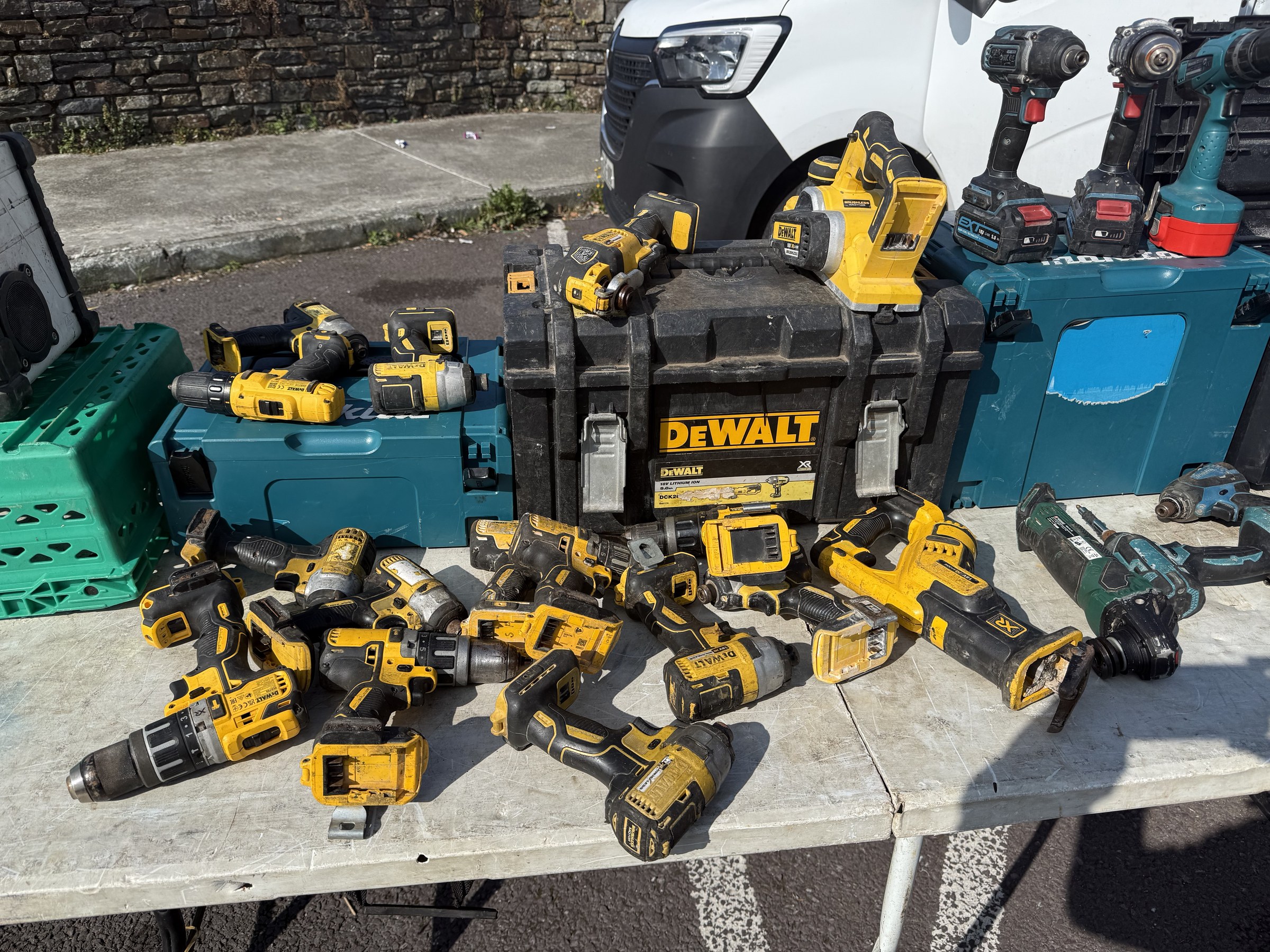 A market table covered with second-hand power tools