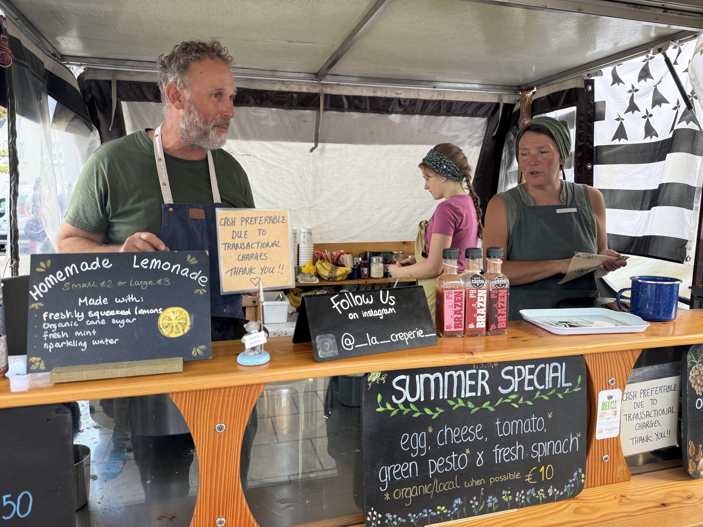 The smiling owner of a French crêpe and galette stall
