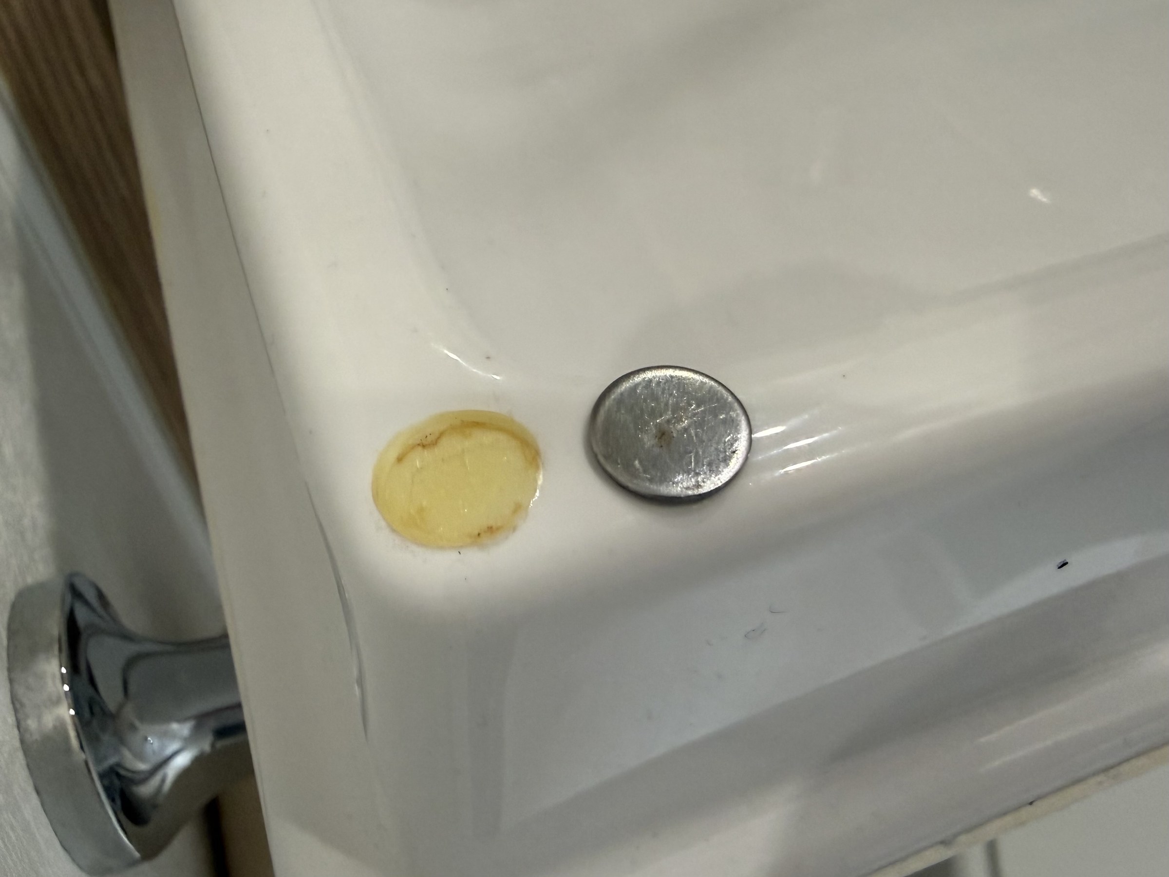A loose metal disc beside the circular mark where it should be bonded