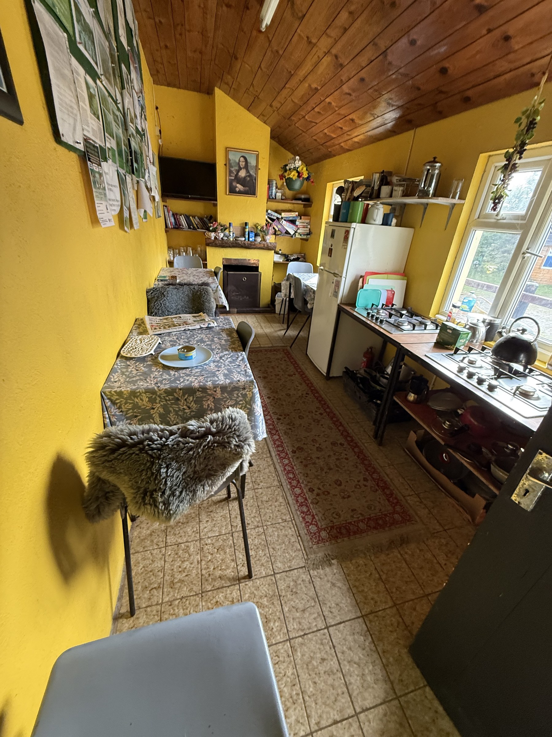 The rustic common room and kitchen inside Creveen Lodge campsite