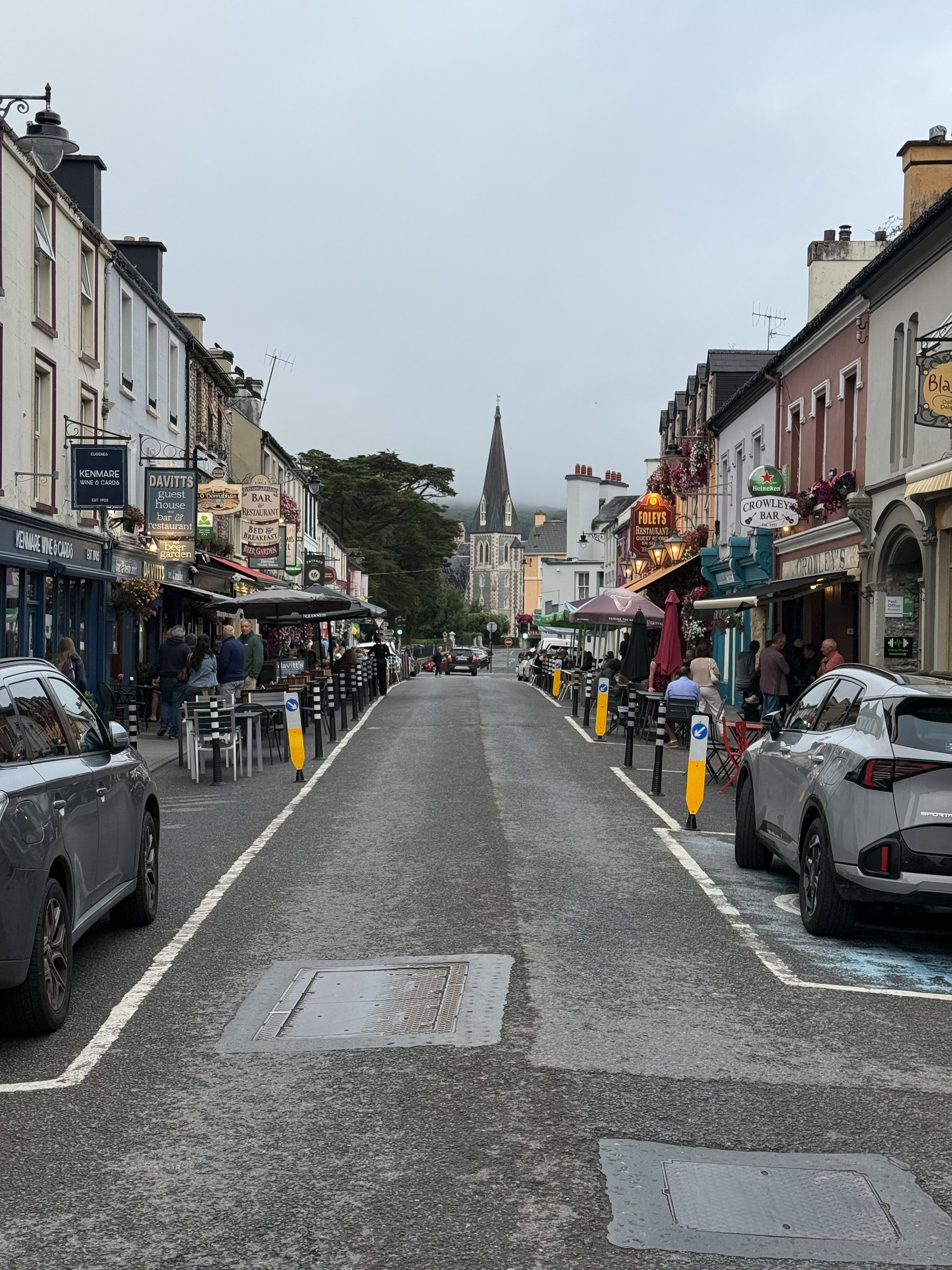 Cars and visitors along Kenmare's colourful main street