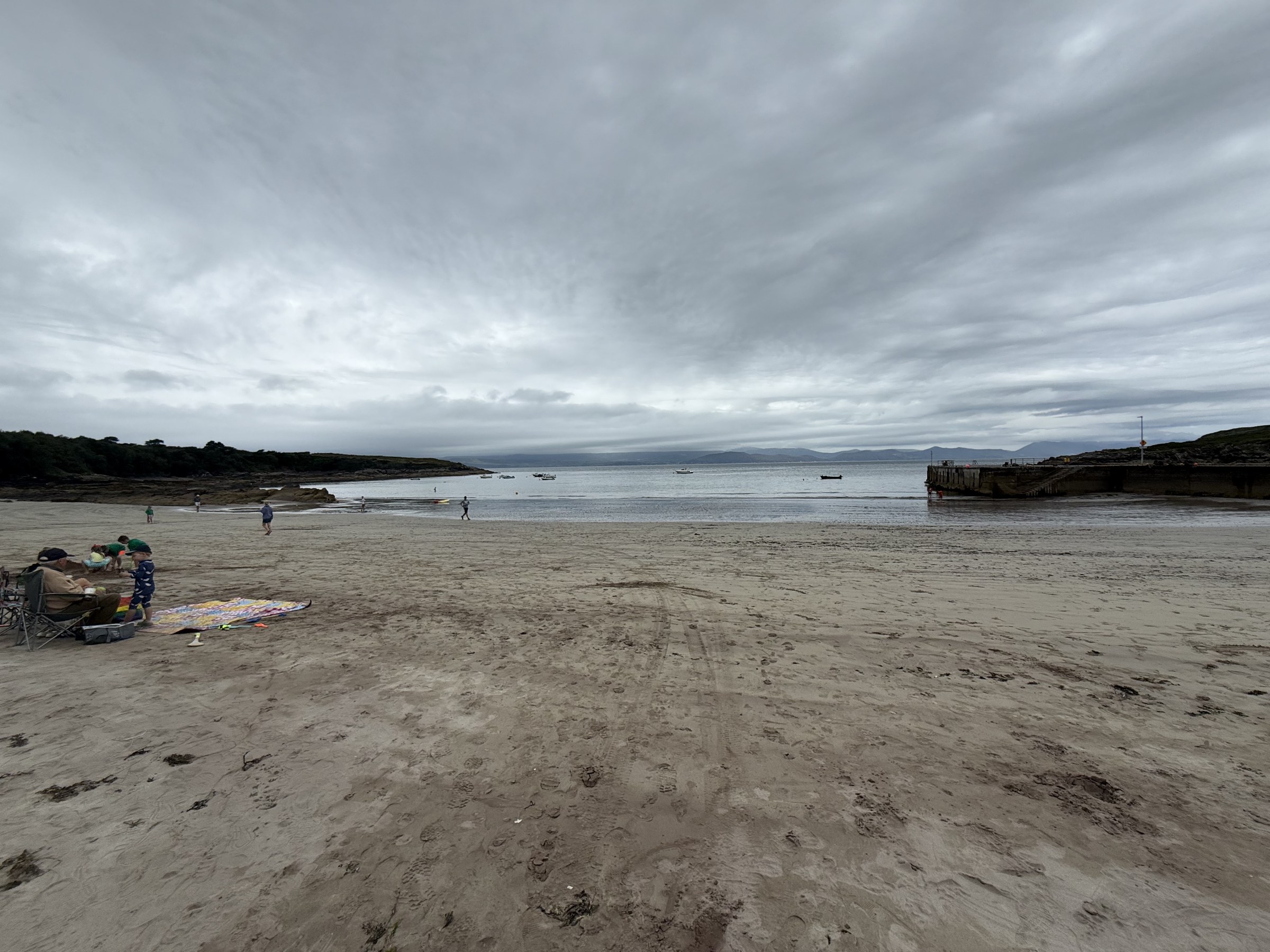 Kells Beach at low tide beneath a grey sky
