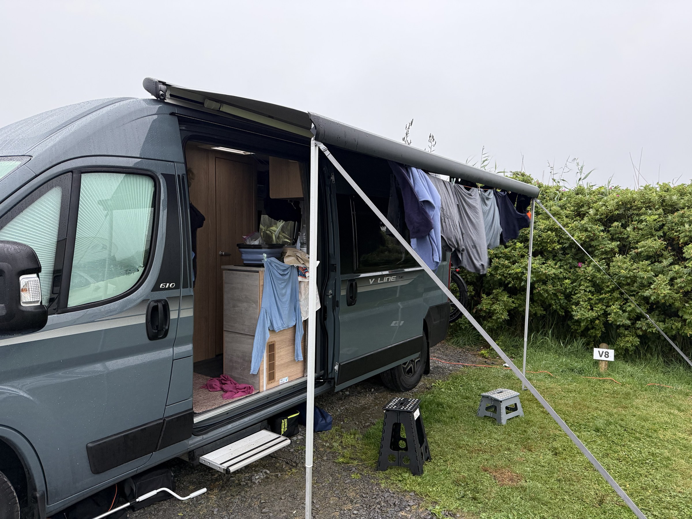 Wet laundry hanging beneath Ollie's partly extended awning