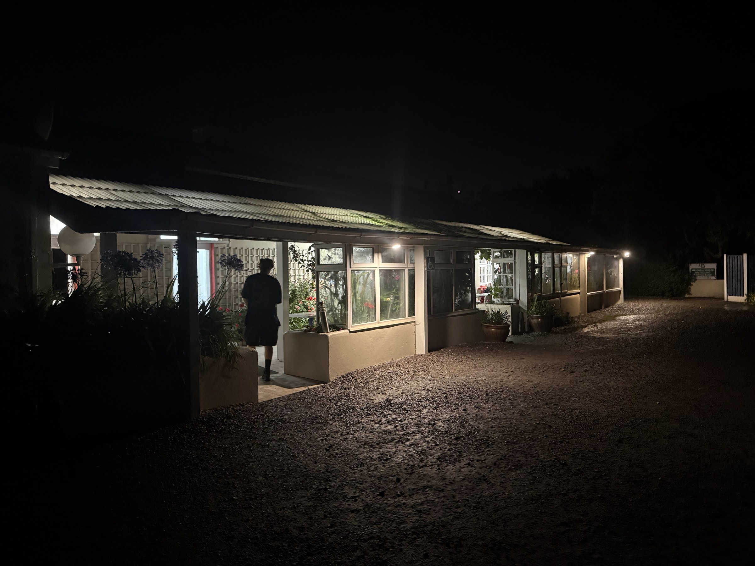 The lit communal building at Mannix Point campsite after dark