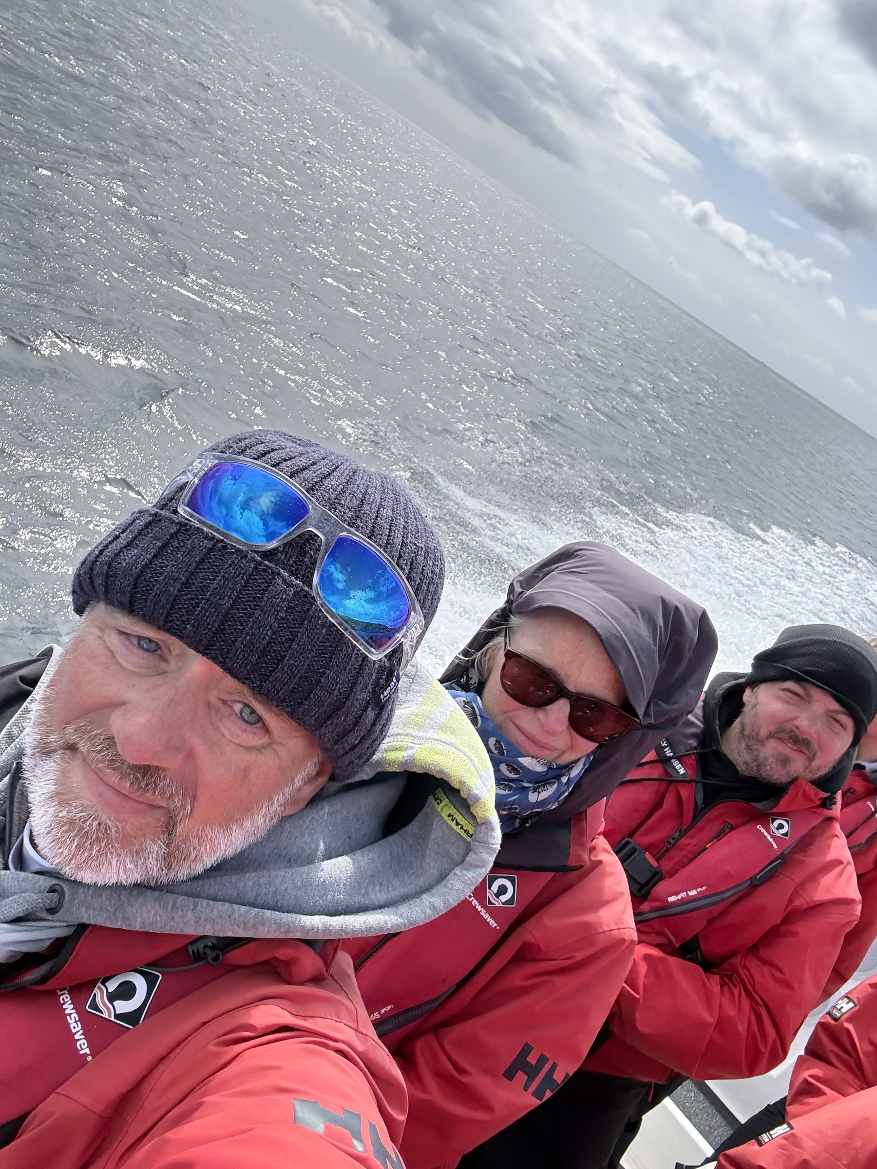 John, Sue and another passenger taking a windswept selfie aboard the RIB
