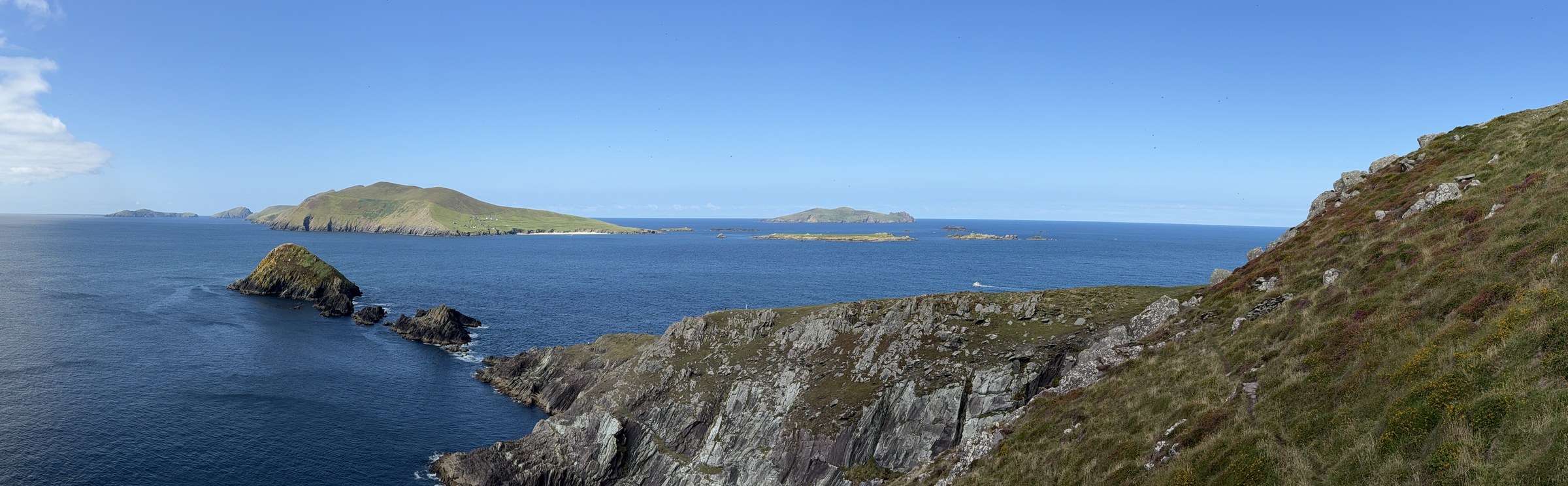 The Blasket Islands spread across the blue Atlantic beyond Dunmore Head