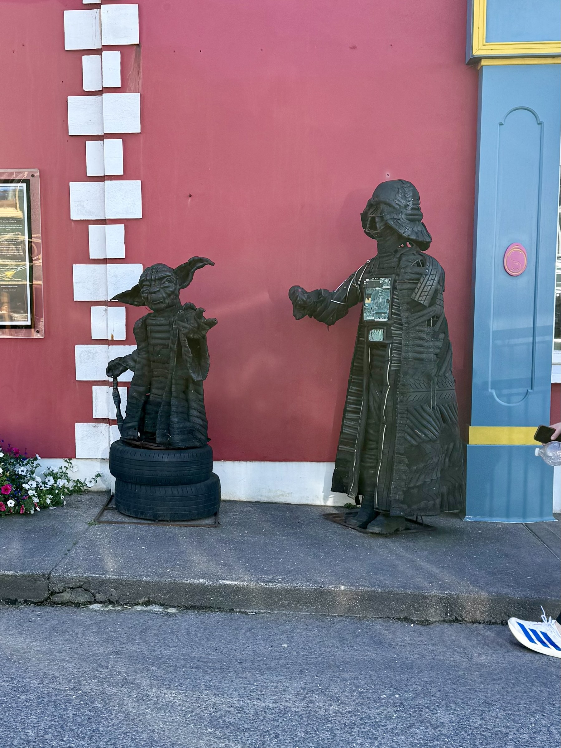 Small Star Wars character statues outside a building in Ballyferriter