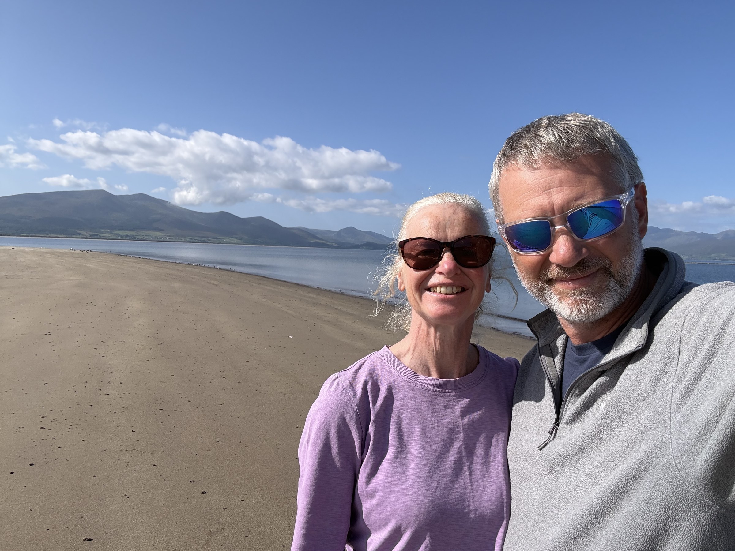 Sue and John on the beach with the Dingle mountains behind