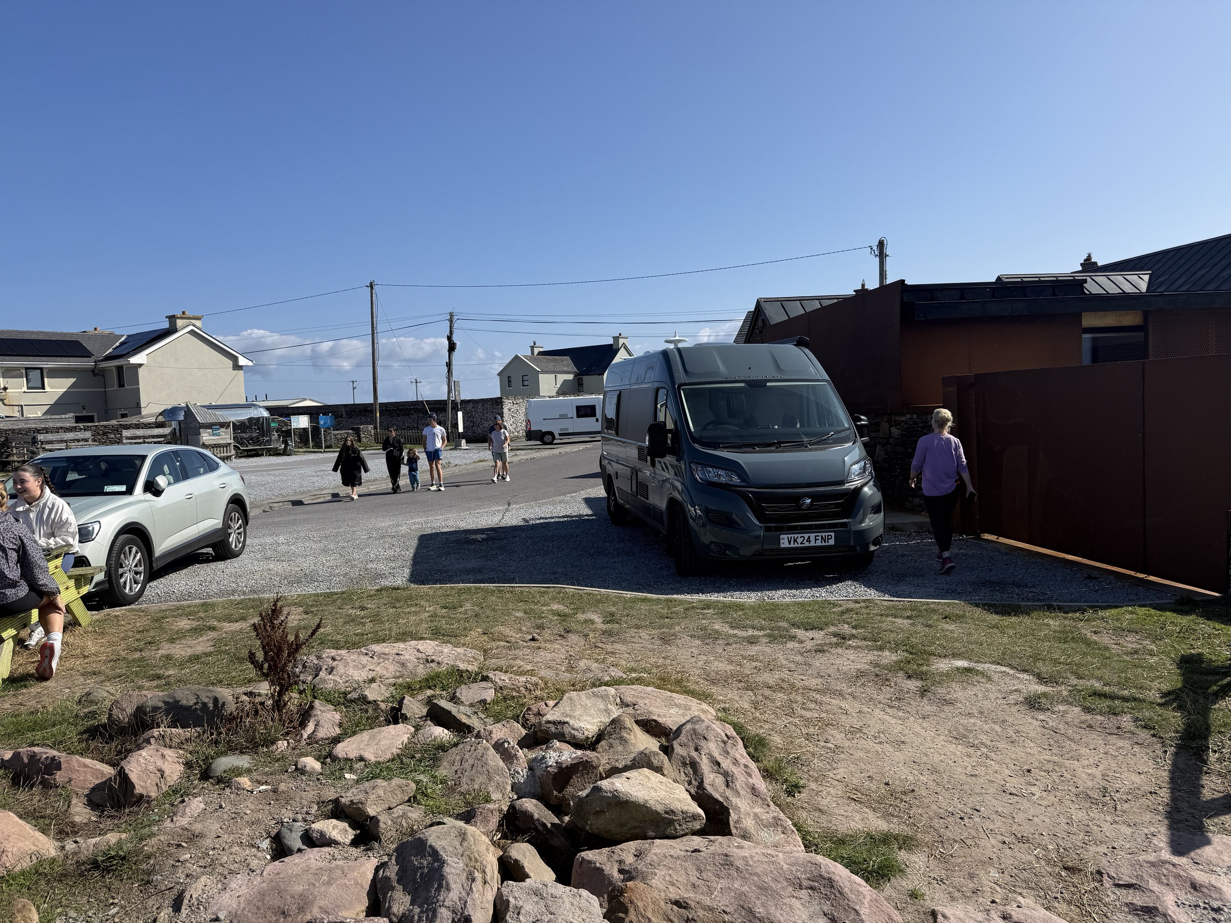 Ollie parked beside the rocky shoreline at the end of the Maharees road