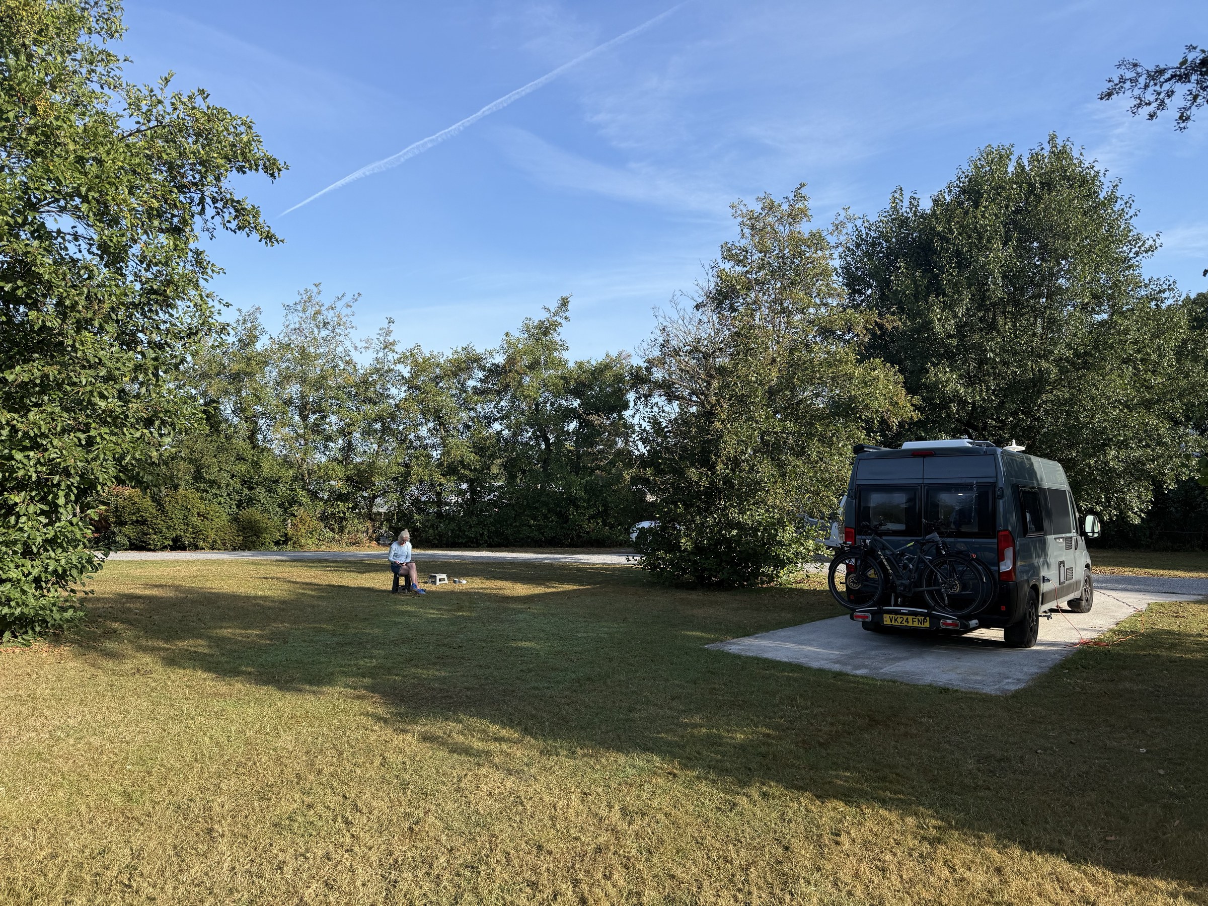 Ollie parked beneath the trees at the Apple Farm campsite