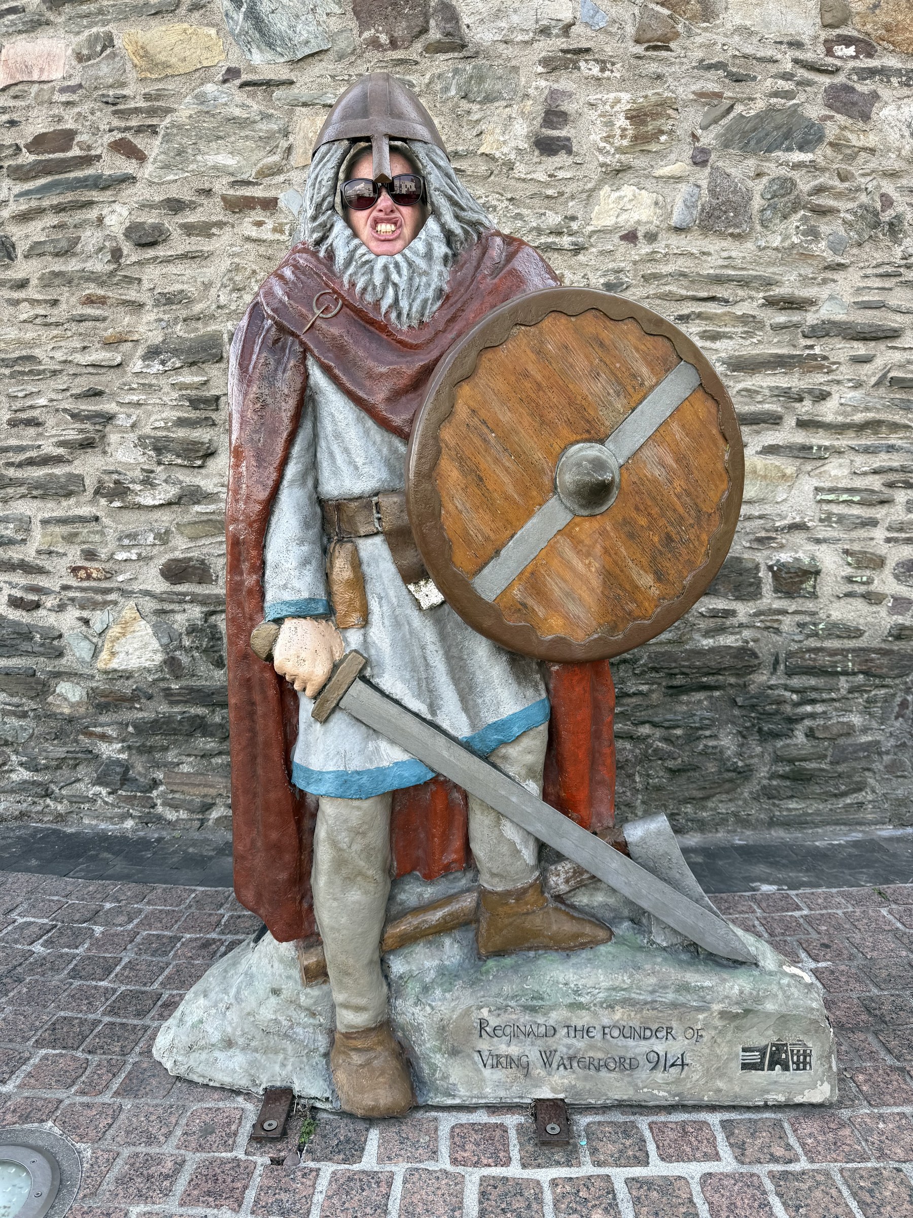 Sue putting her face through a painted Viking warrior cut-out