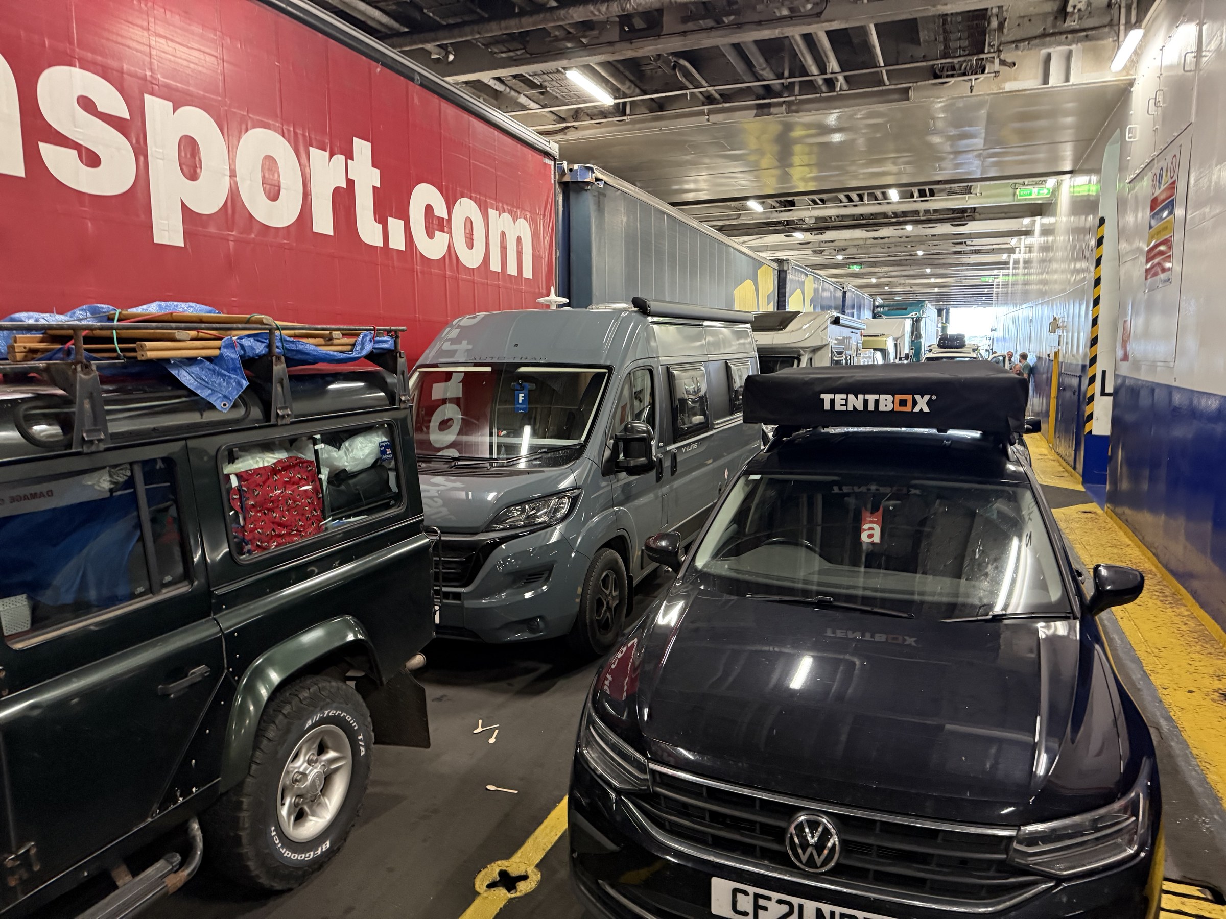 Cars and campervans packed onto the vehicle deck of the ferry