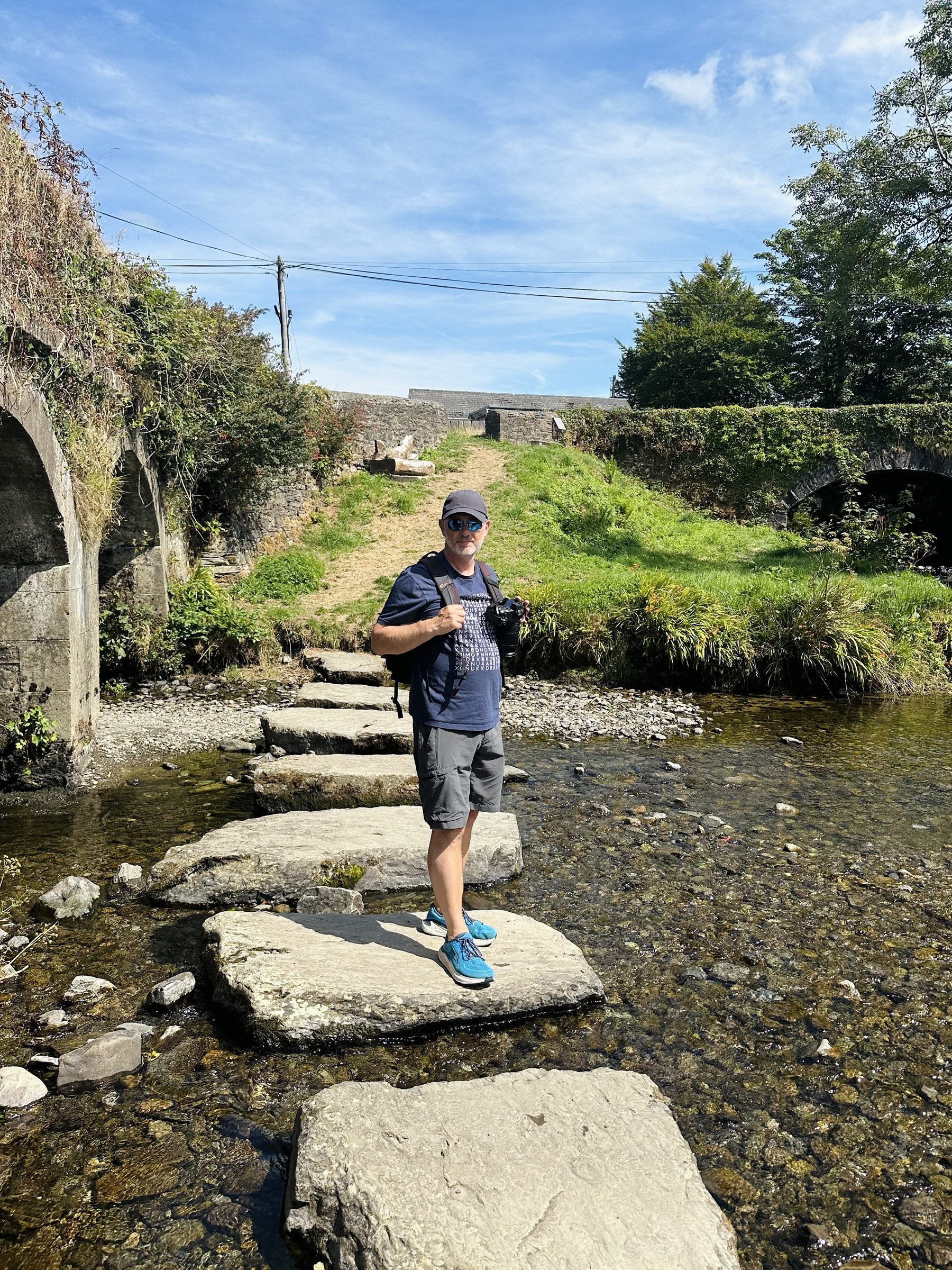 John standing on the River Ilen stepping stones