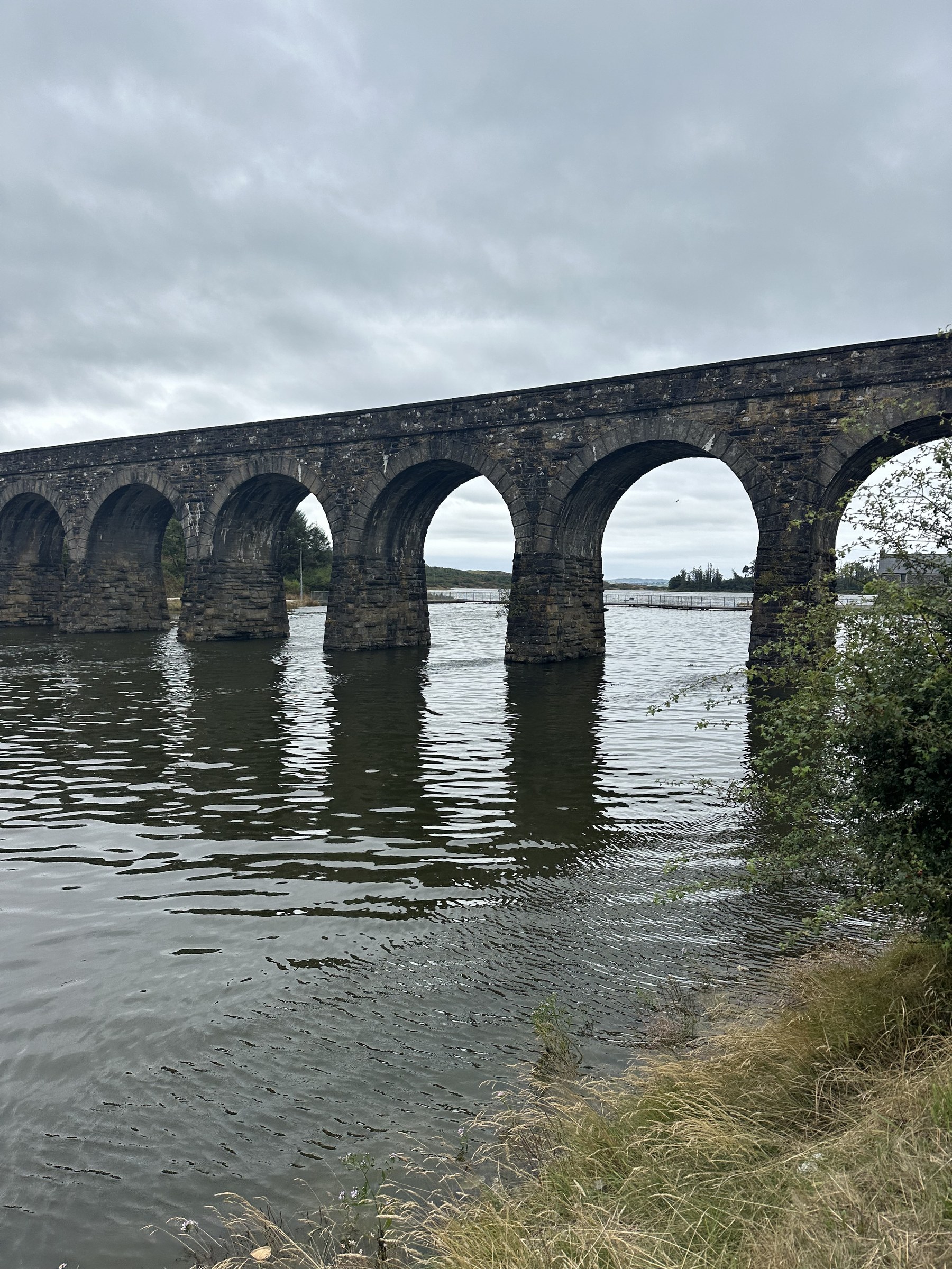 Ballydehob's 12-arch railway bridge reflected in the water