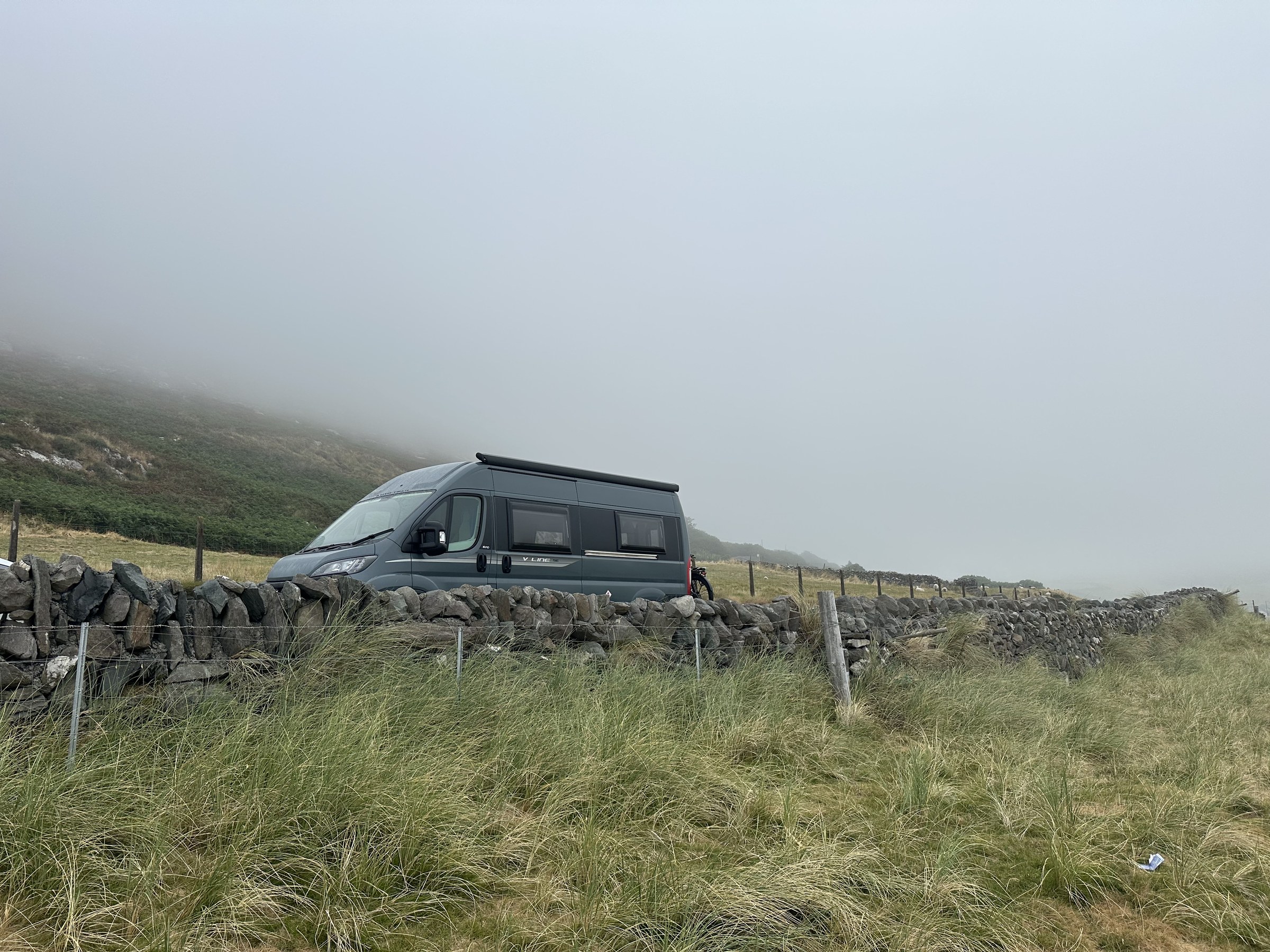 Ollie parked beside the coast in thick mist
