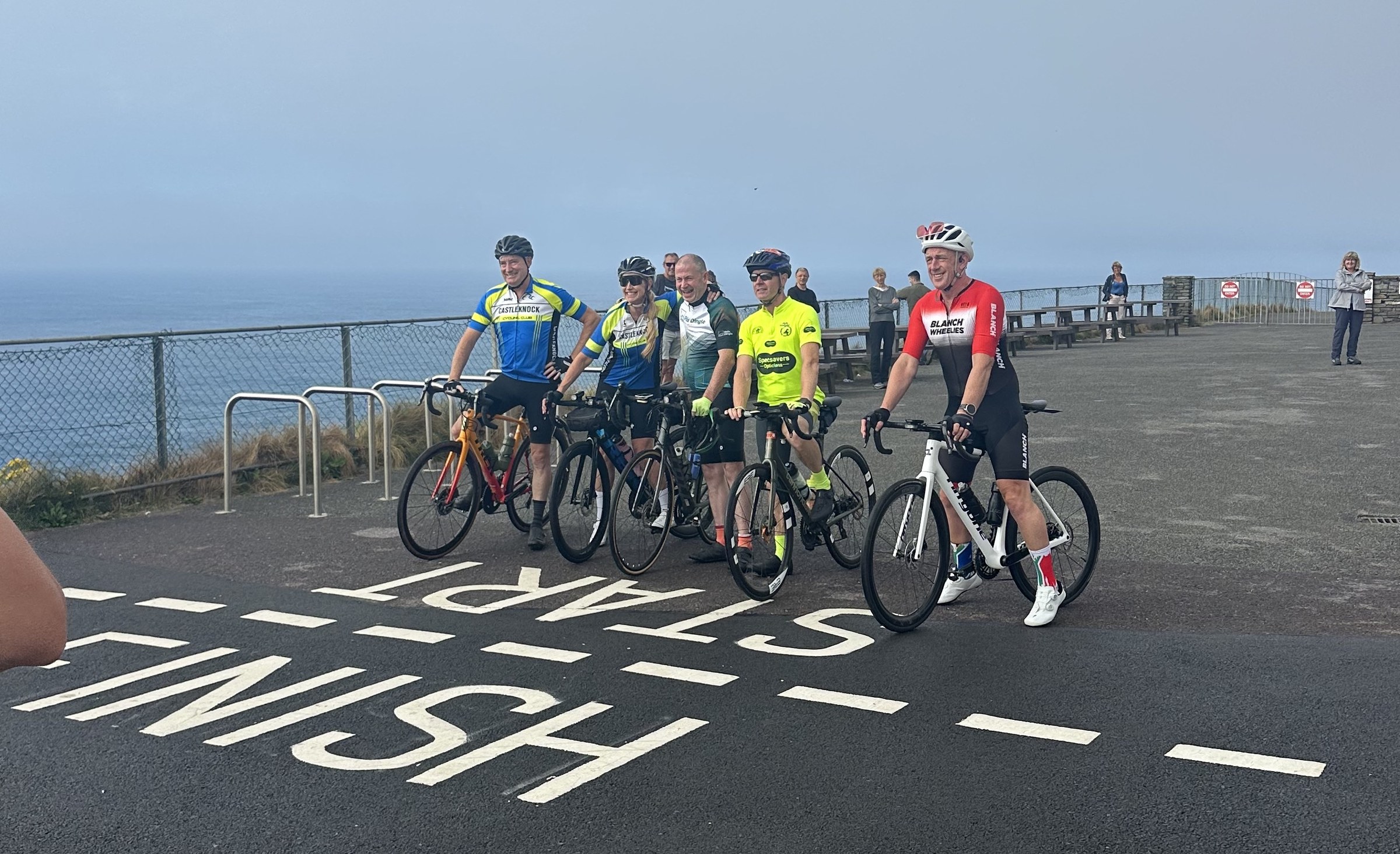 Five cyclists preparing to set off from Mizen Head