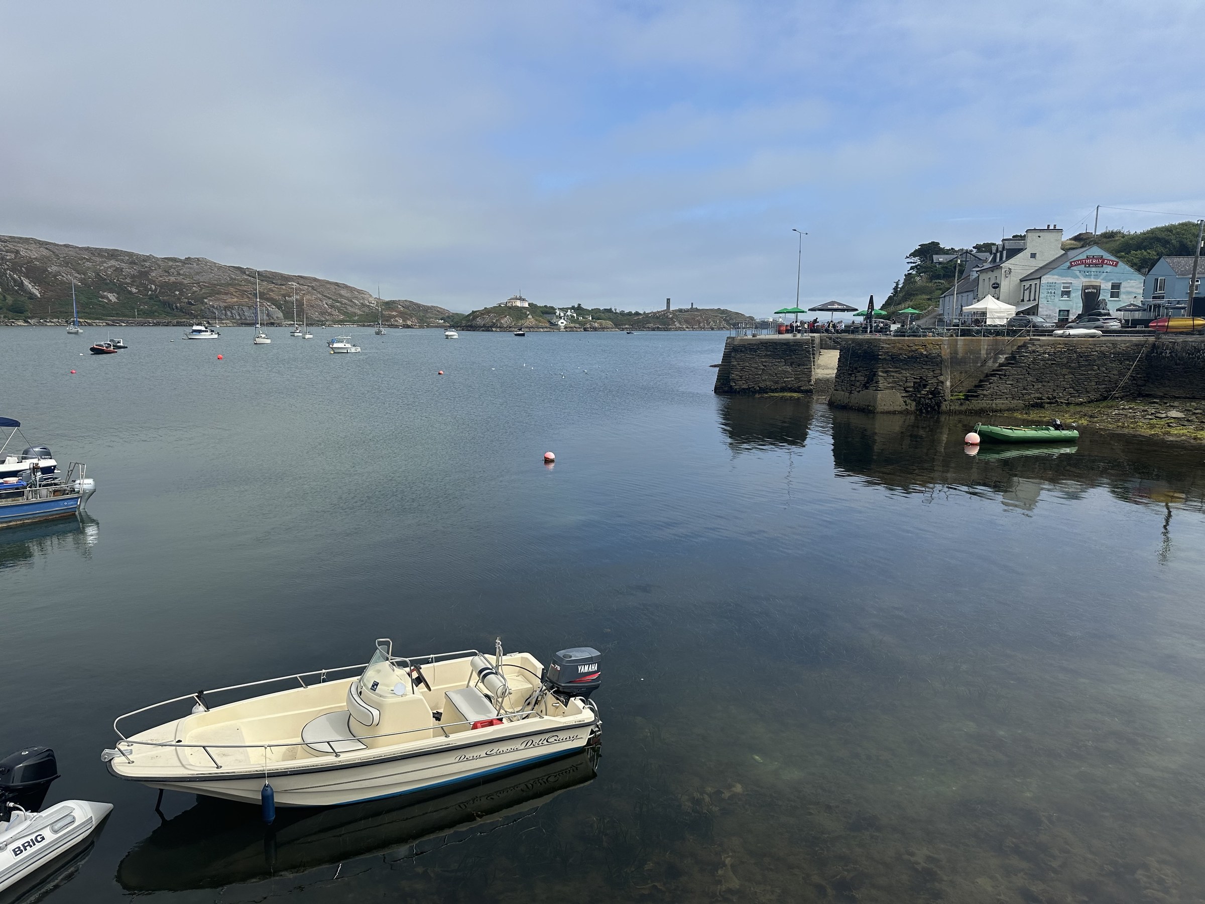 Small boats moored in the sheltered harbour at Crookhaven