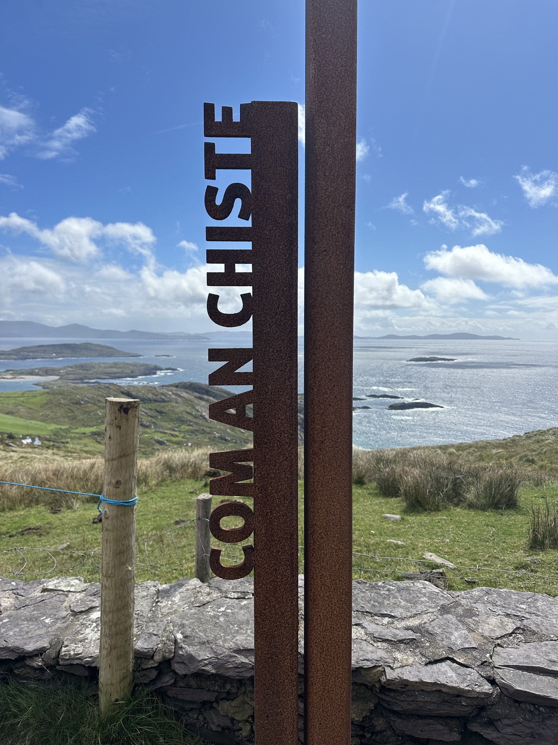 A rusted Com an Chiste marker overlooking the Kerry coast