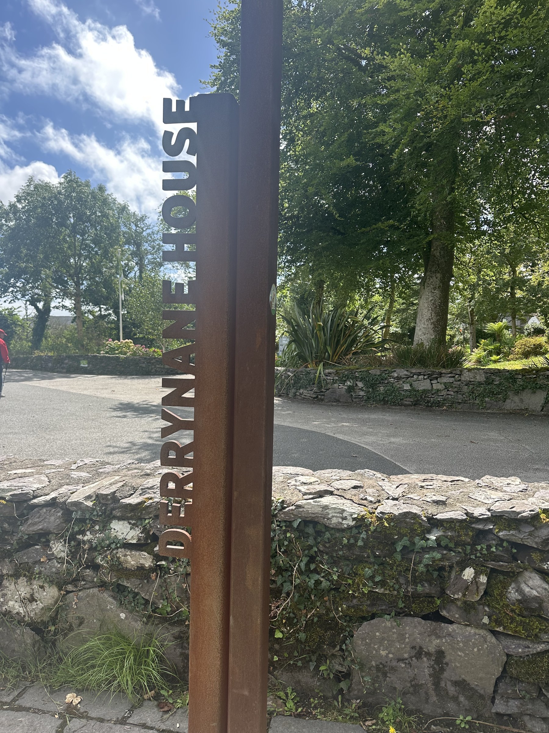 The rusted entrance marker for Derrynane House