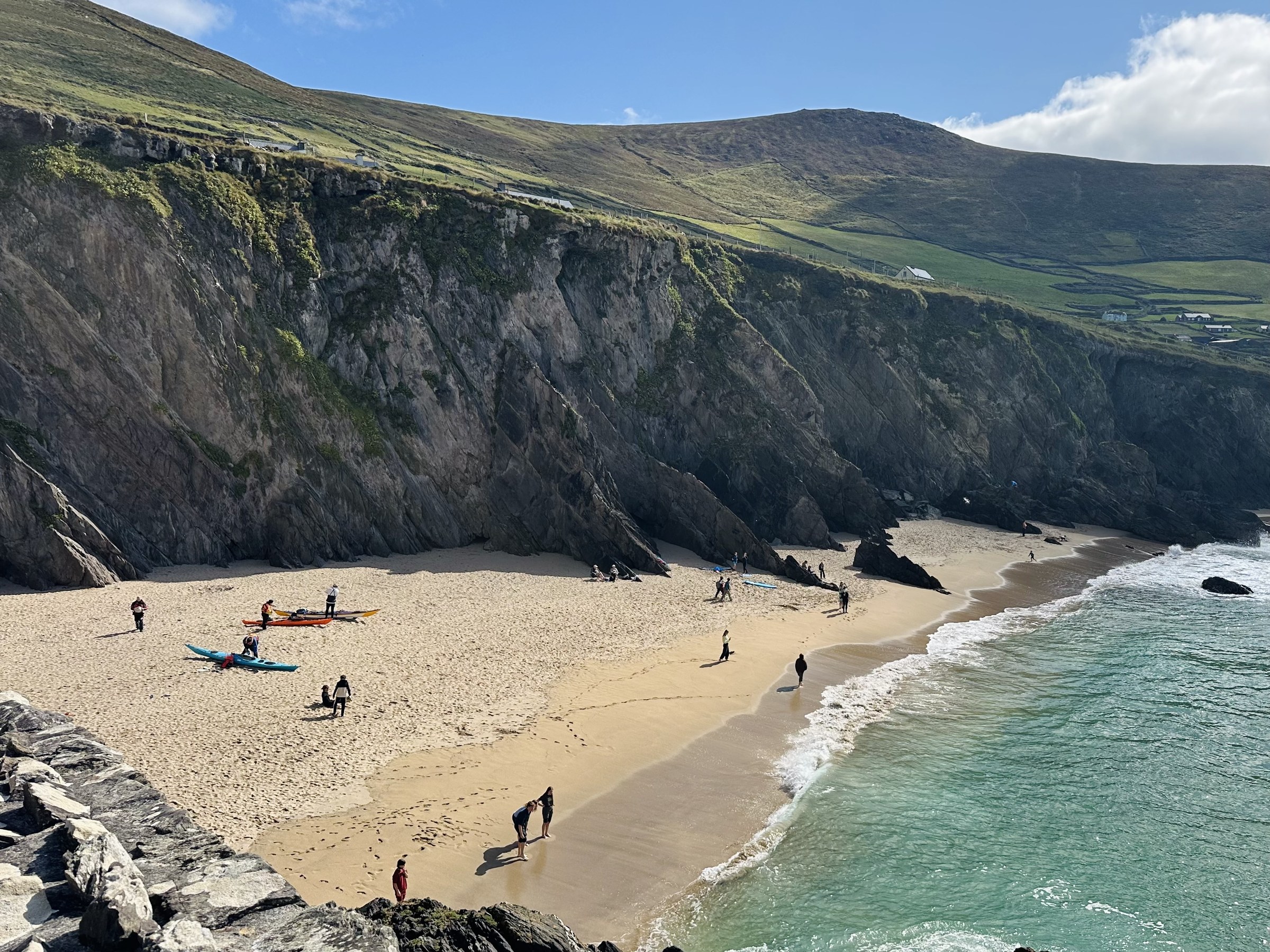 Swimmers and kayakers on Coumeenoole Beach below Dunmore Head