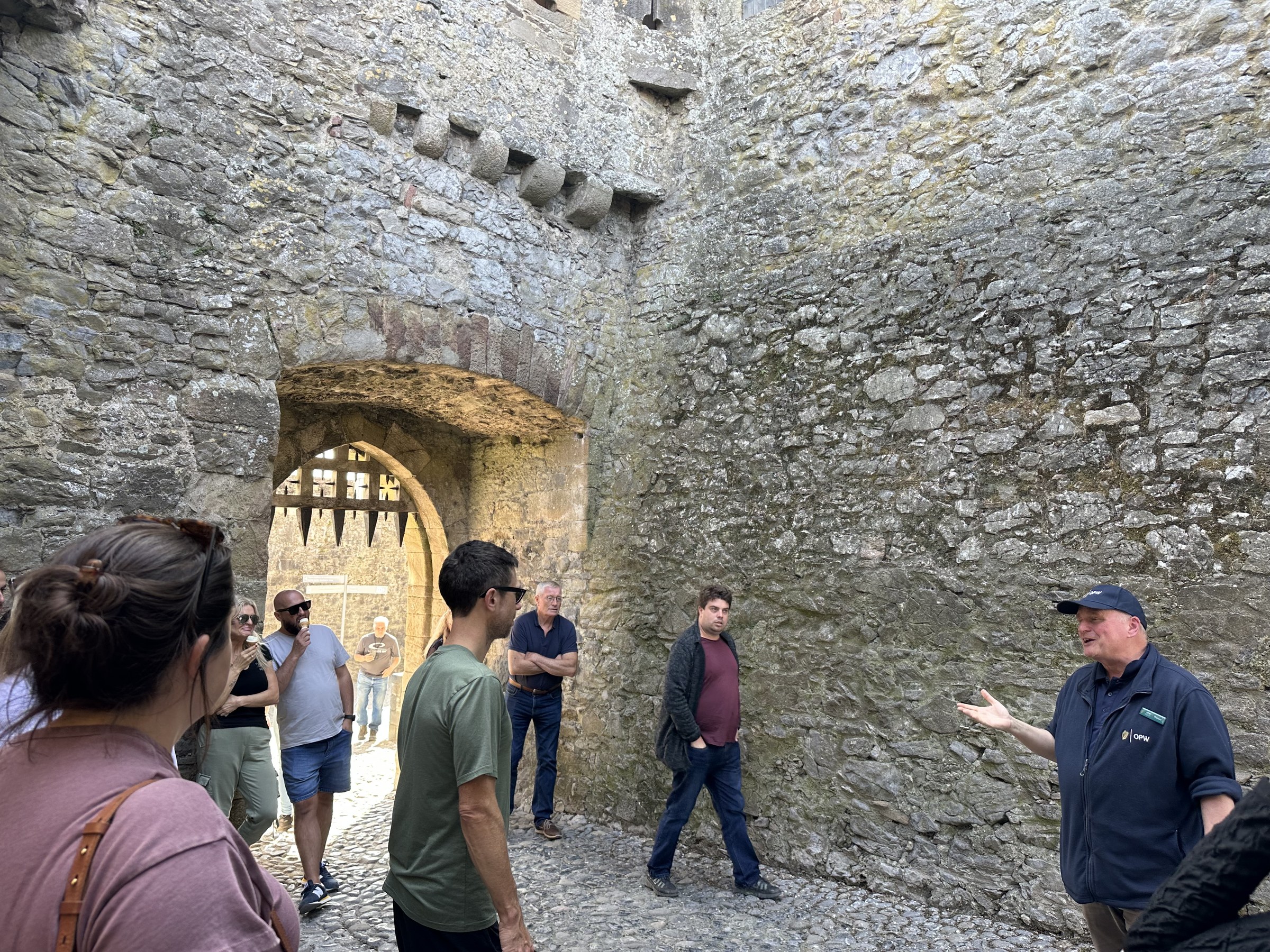 Rob addressing the tour beside an arched doorway in Cahir Castle
