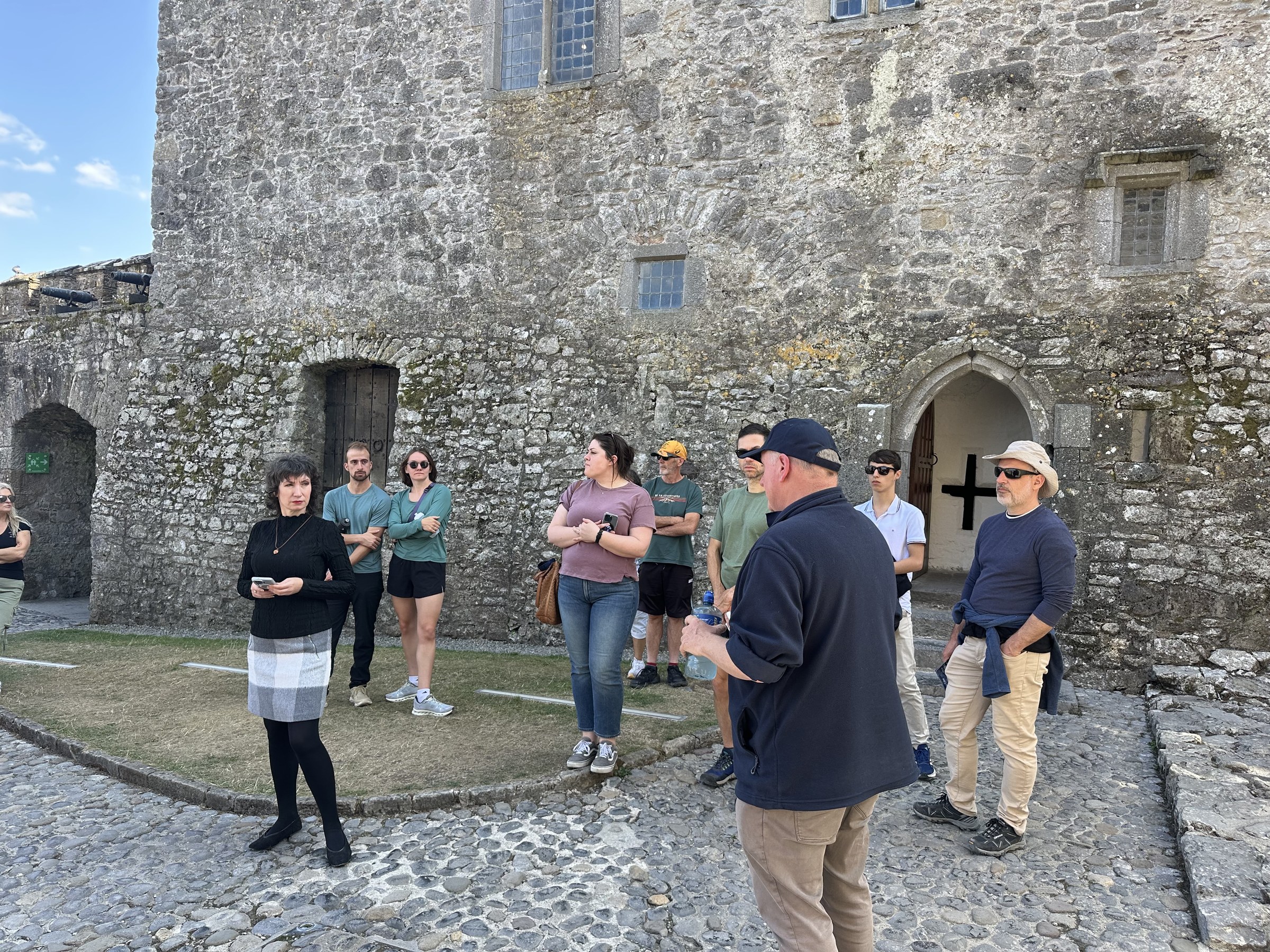 Visitors listening to Rob in the courtyard of Cahir Castle