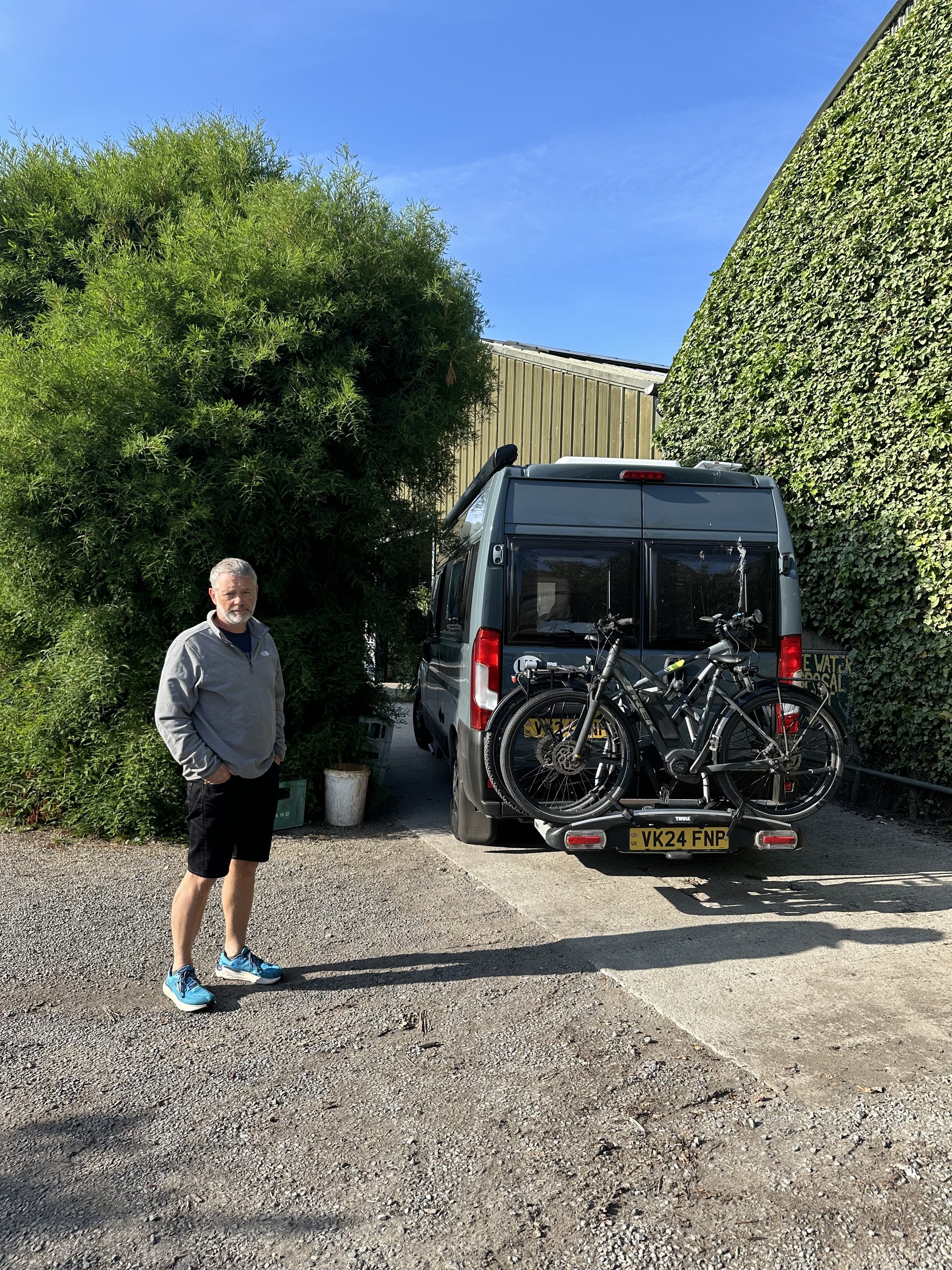 John standing beside Ollie at the campsite service point
