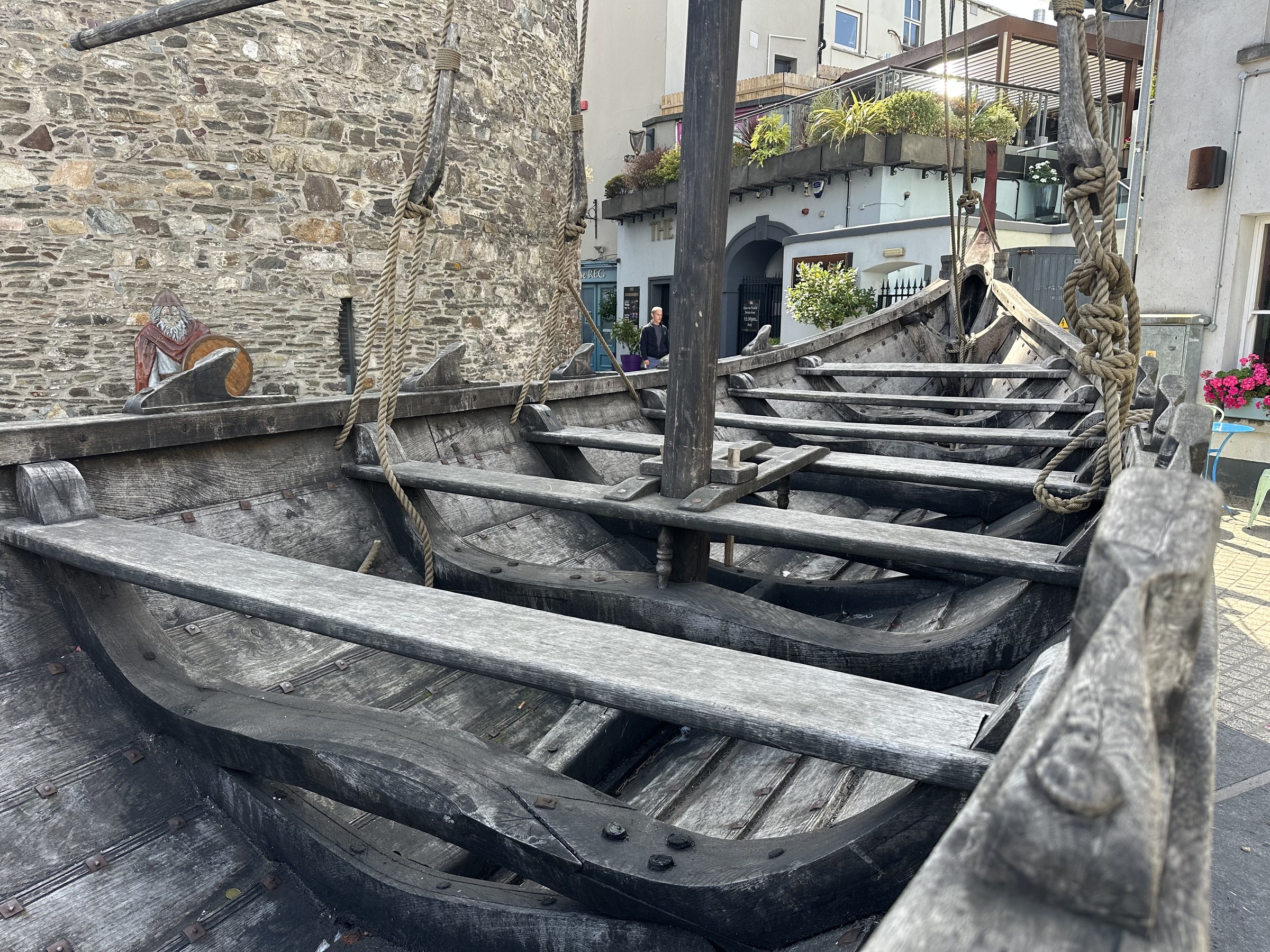 A replica wooden Viking boat displayed beside Reginald's Tower