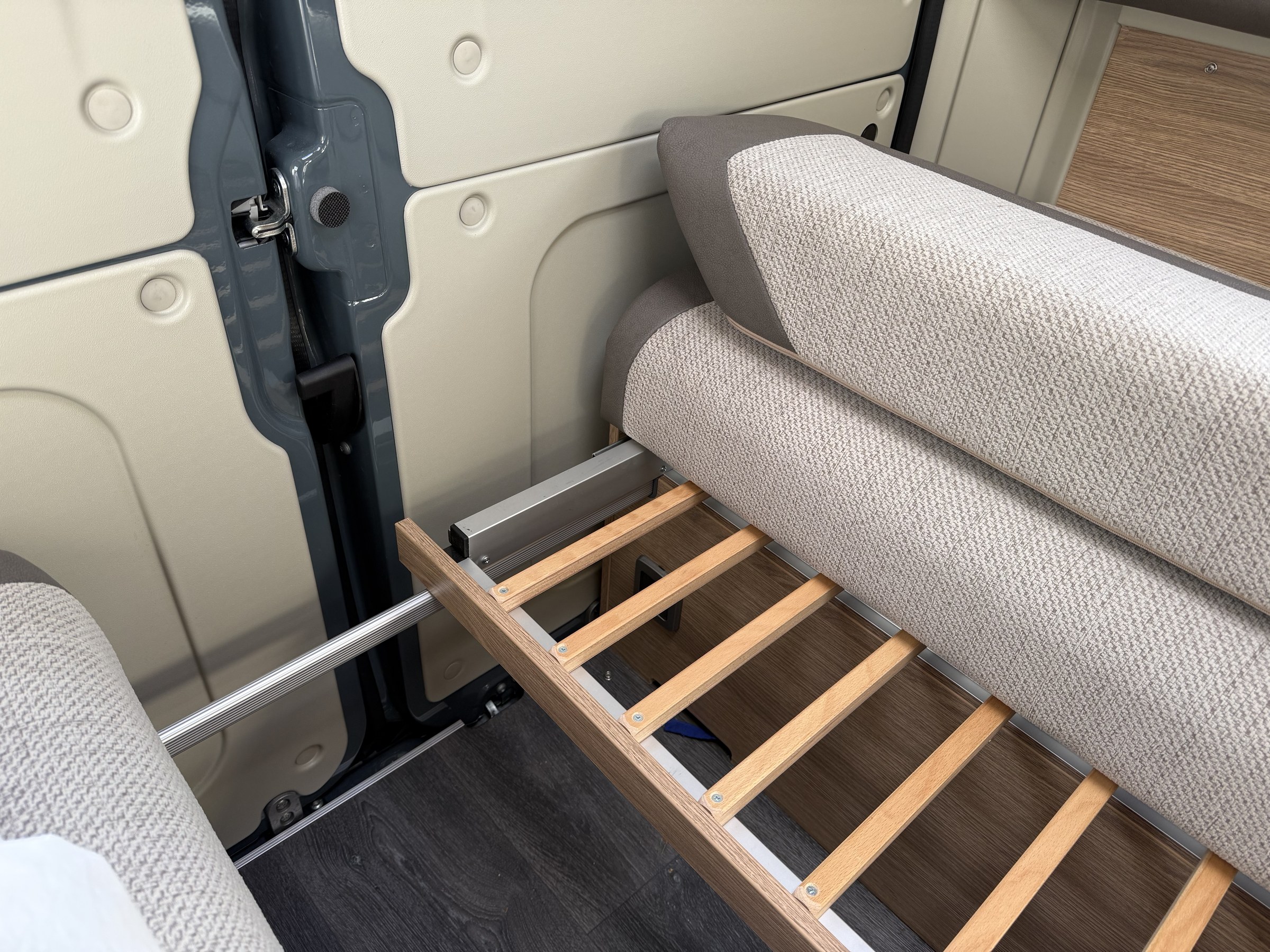 The extending rails and support bar used to turn the single beds into a double